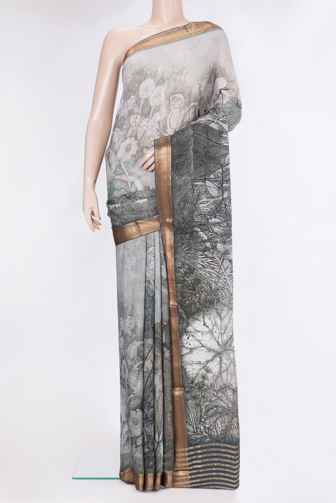 Grey Crepe Saree with Printed design on the body and Zari Border.  displayed on a mannequin