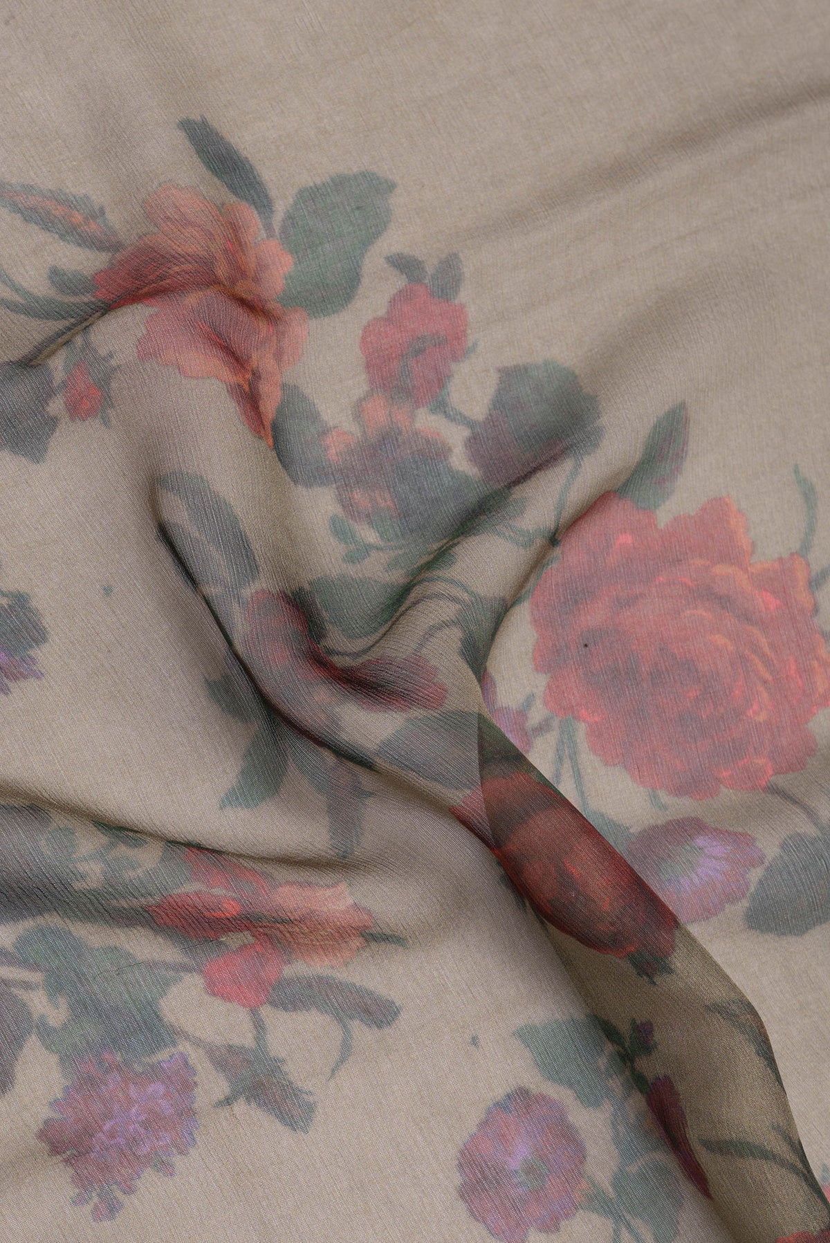 Close up of Mehandi Green Chiffon Saree with Floral Print on the body and Zari Border.  displaying folds