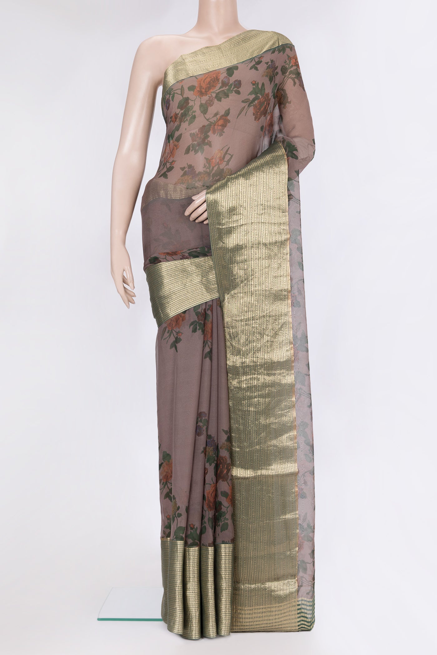 Brown Chiffon Saree with Printed design on the body and Zari Border.  displayed on a mannequin