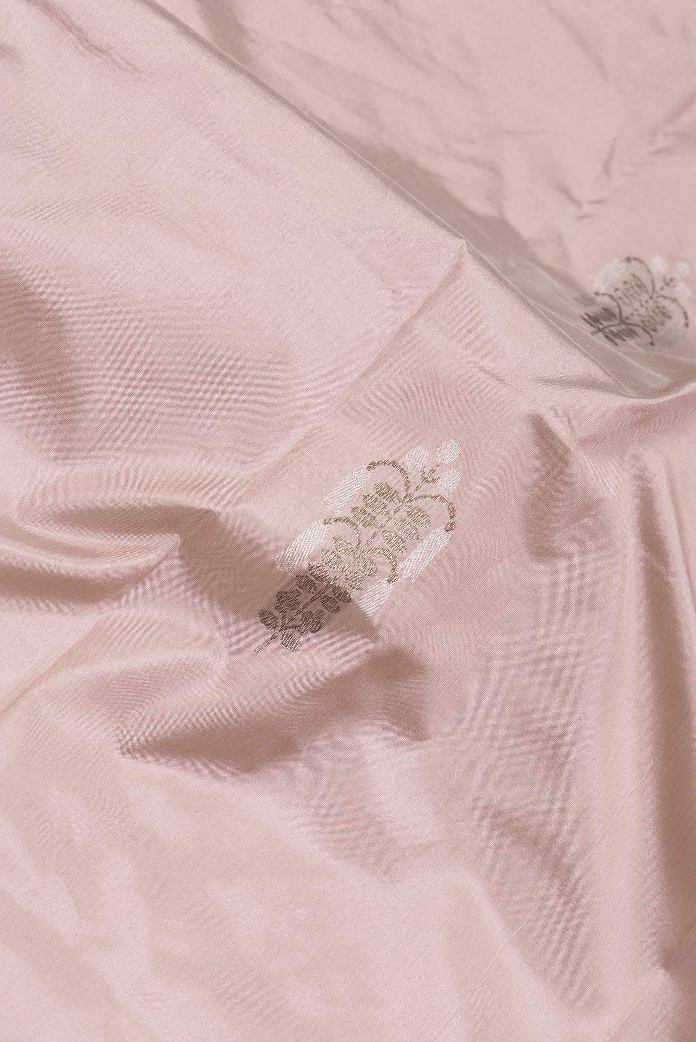 Close up of Rose Gold Dual Tone Banarasi Silk Saree with Zari Butta on the body and Zari Border.  displaying folds