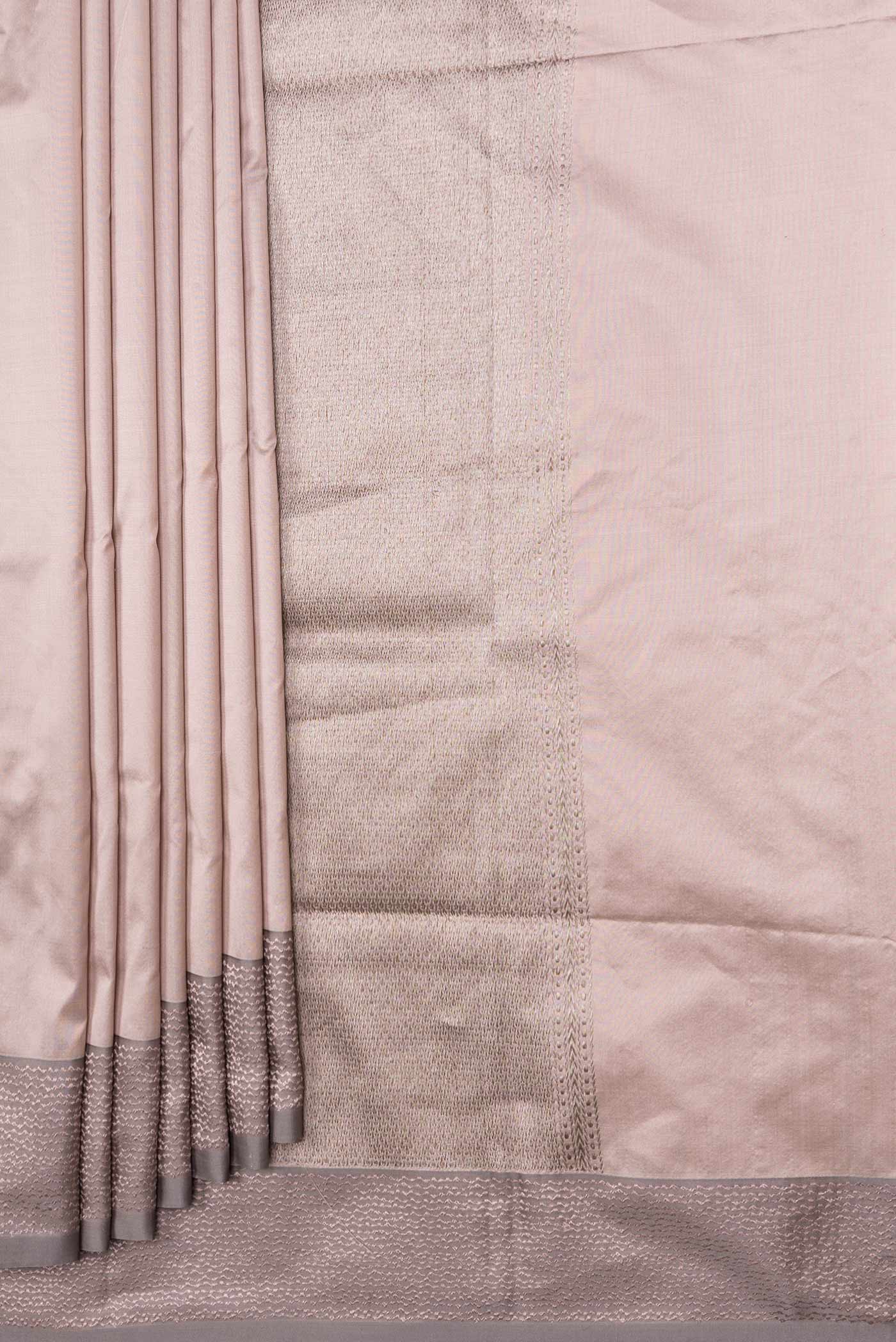 Pleats and pallu of Rose Gold Dual Tone Banarasi Silk Saree with Zari Butta on the body and Zari Border. 