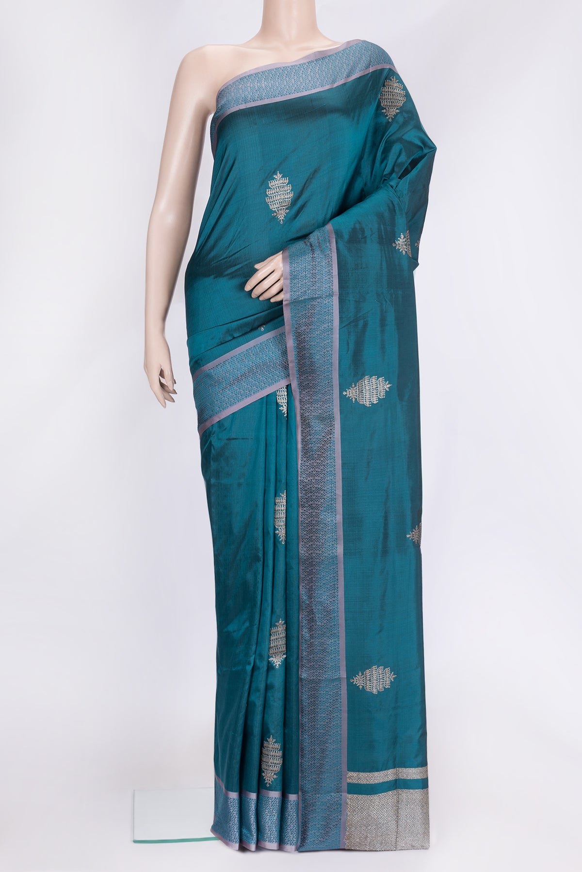 Peacock Blue Dual Tone Banarasi Silk Saree with Zari Butta on the body and Thread Border.  displayed on a mannequin