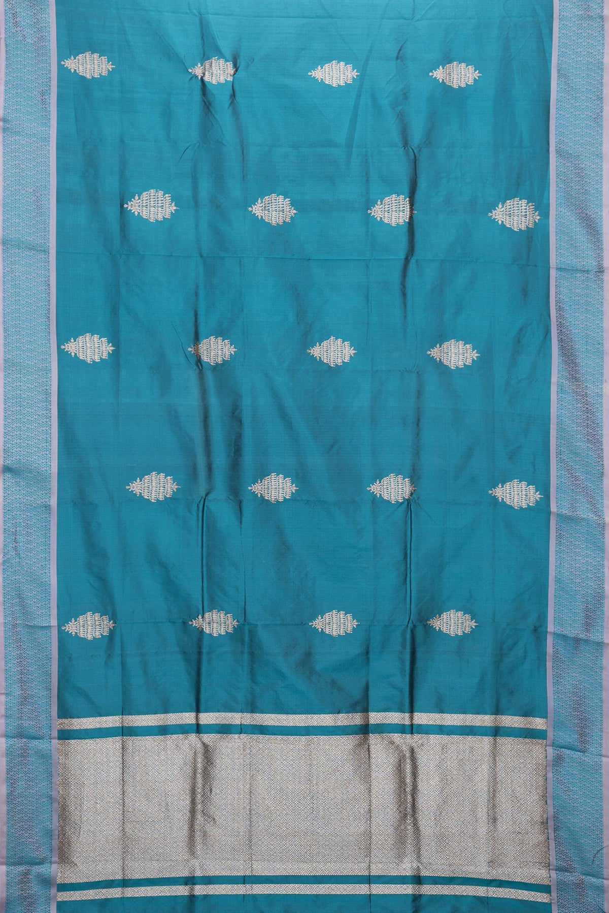 Flat view of Peacock Blue Dual Tone Banarasi Silk Saree with Zari Butta on the body and Thread Border. 
