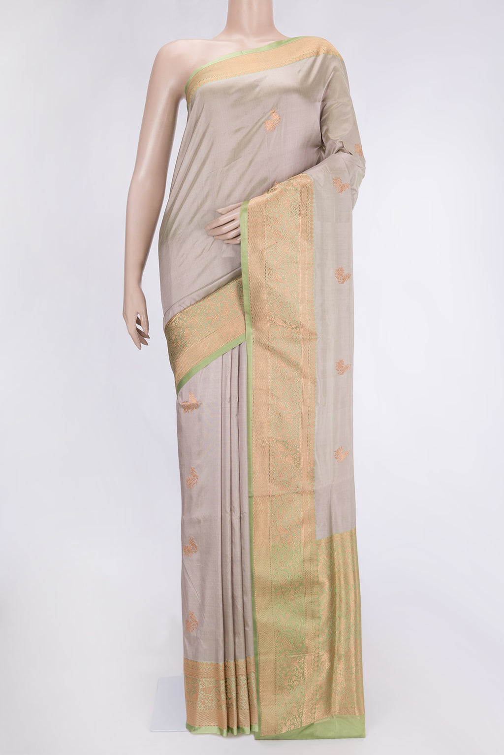 Beige Dual Tone Banarasi Silk Saree with Zari Butta on the body and Zari Border.  displayed on a mannequin