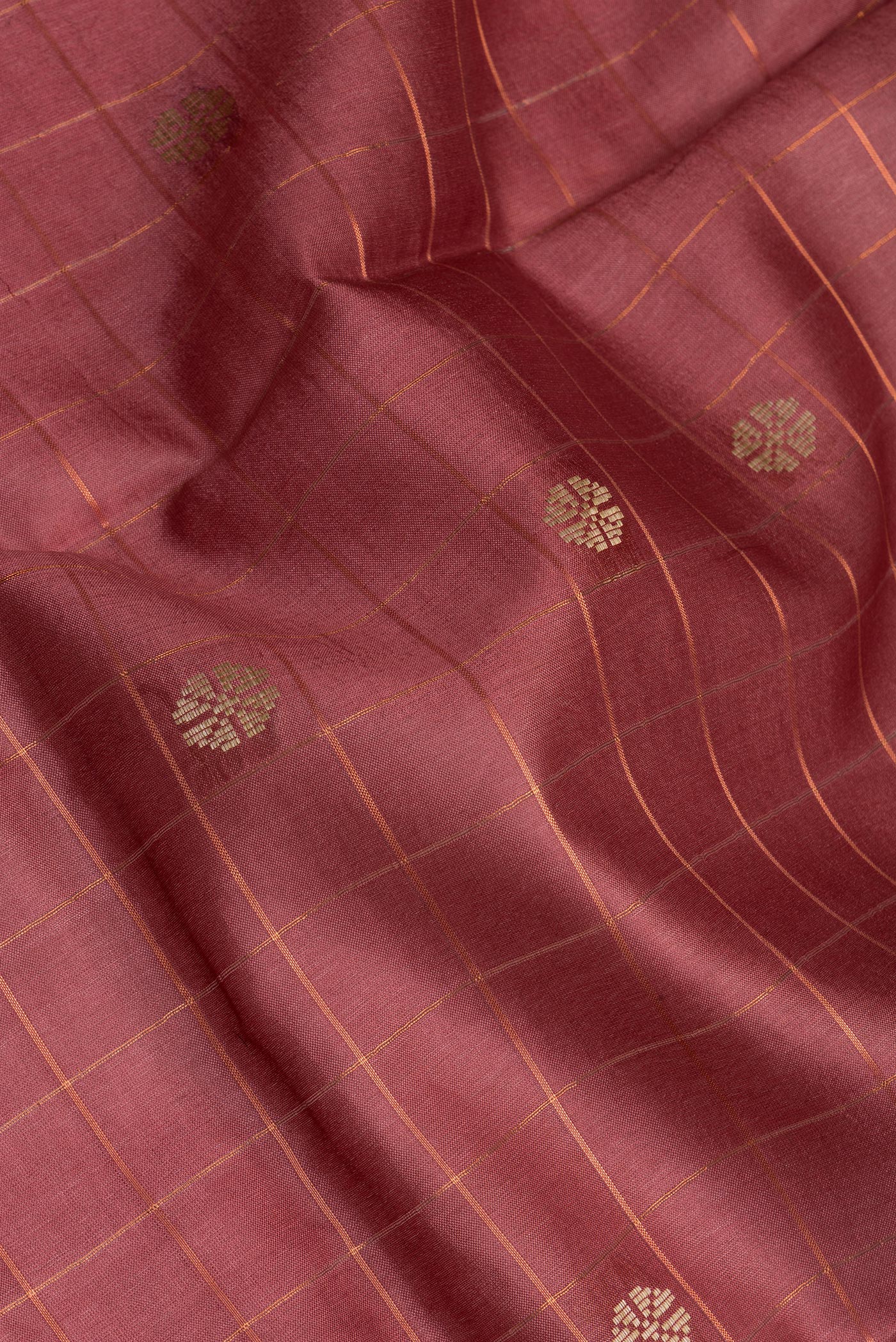 Close up of Maroon Tussar Silk Saree with Checked design on the body and Zari Border.  displaying folds