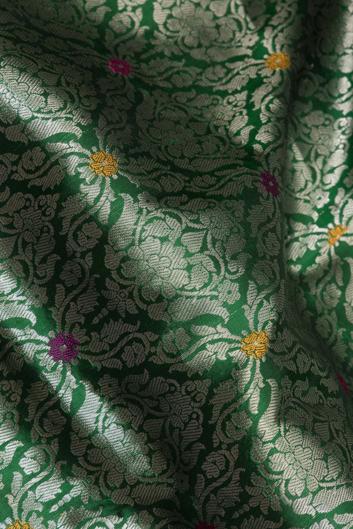 Close up of Pure Silk Green Banarasi Saree with Zari Brocade on the body and Zari Border.  displaying folds