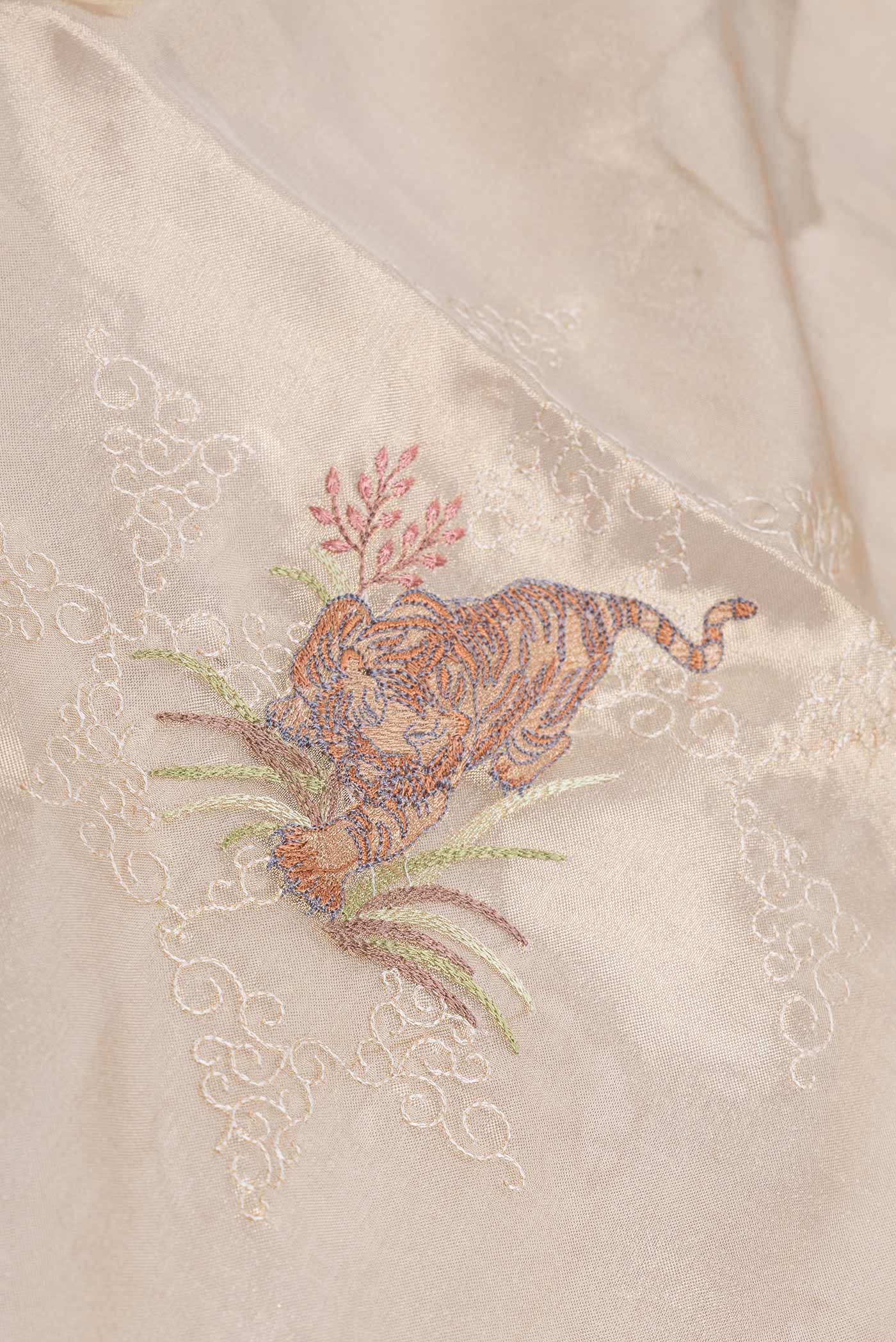Close up of Gold Dual Tone Organza Silk Saree with Embroidery on the body and Embroidery Border displaying folds