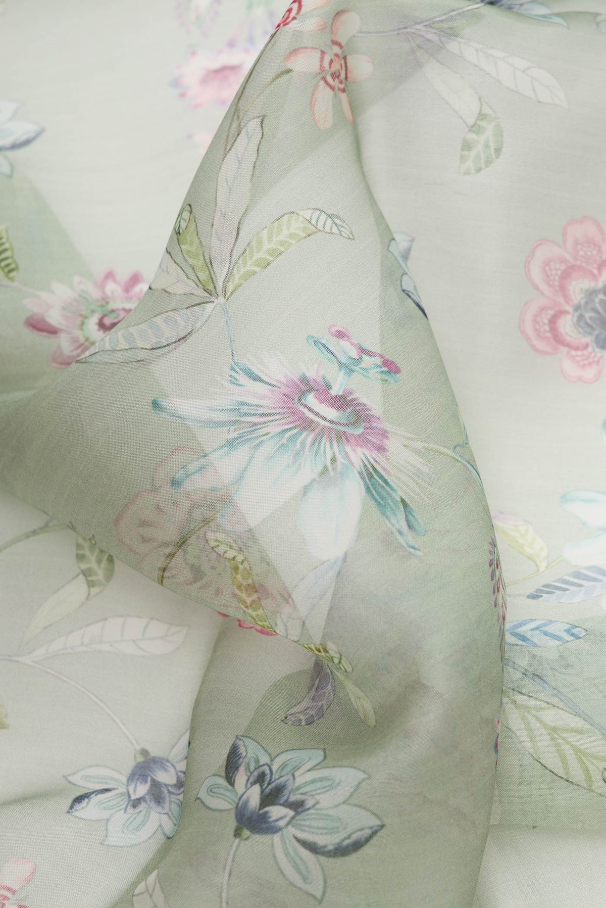 Close up of Green Dual Tone Organza Silk Saree with Printed design on the body and Printed Border.  displaying folds