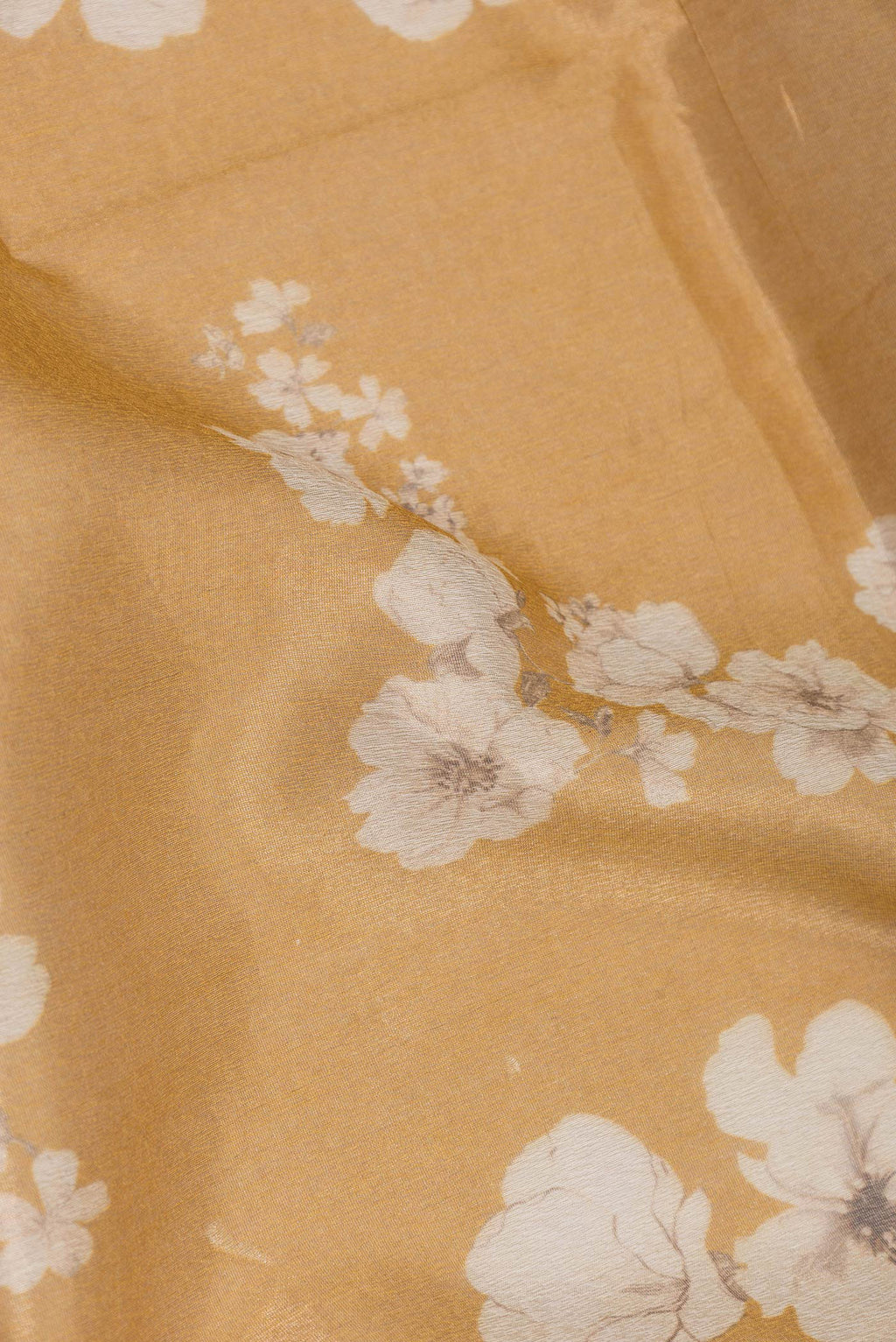 Close up of Mustard Dual Tone Organza Silk Saree with Printed design on the body and Zari Border.  displaying folds
