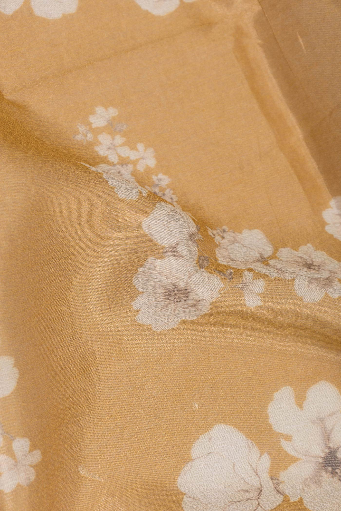 Close up of Mustard Dual Tone Organza Silk Saree with Printed design on the body and Zari Border.  displaying folds