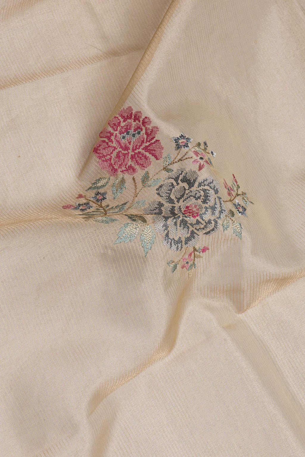 Close up of Gold Dual Tone Organza Silk Saree with Embroidery on the body and Zari Border.  displaying folds
