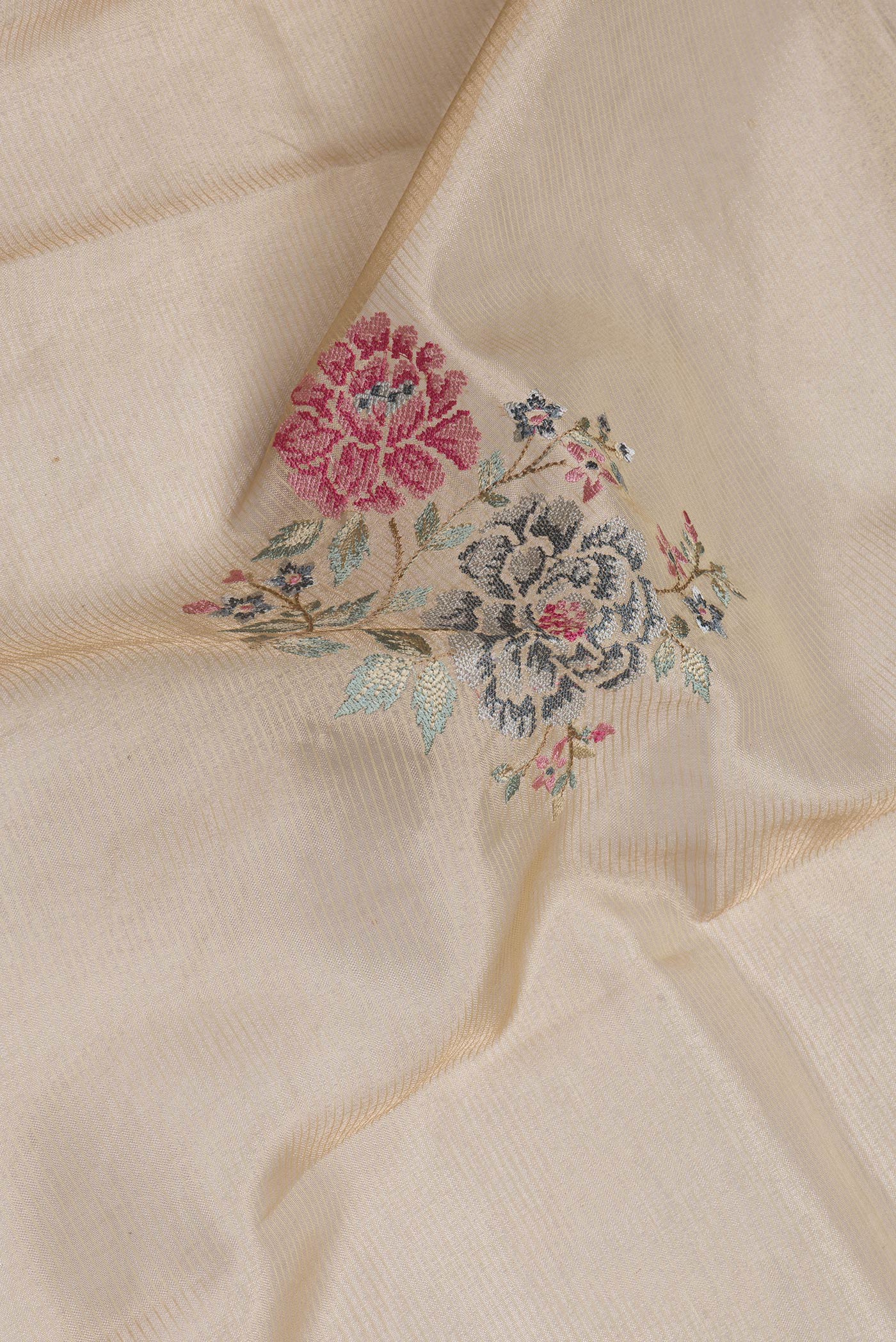 Close up of Gold Dual Tone Organza Silk Saree with Embroidery on the body and Zari Border.  displaying folds