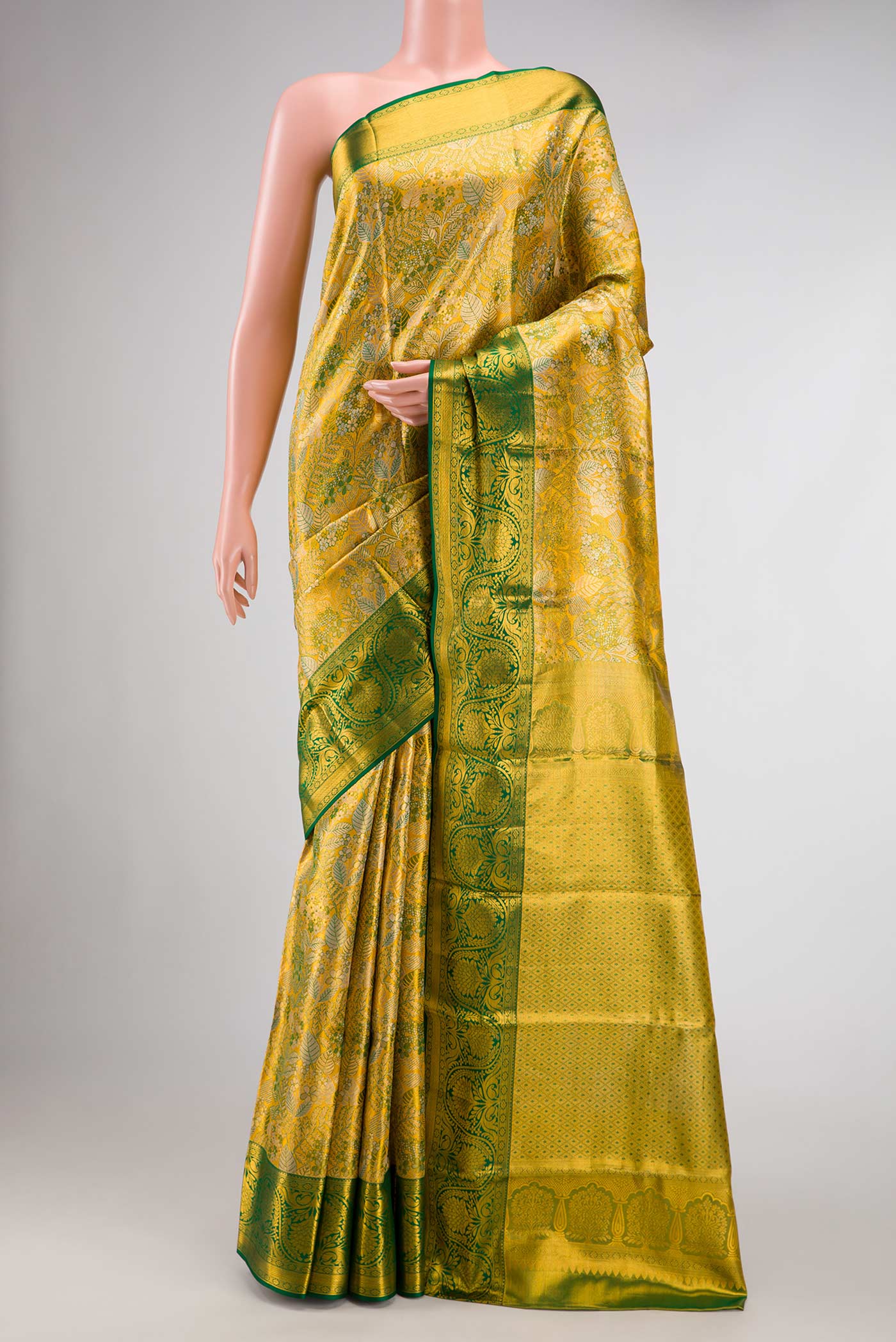 Gold Dual Tone Kanchipuram Tissue Silk Saree with Zari Brocade on the body and Zari Border.  displayed on a mannequin