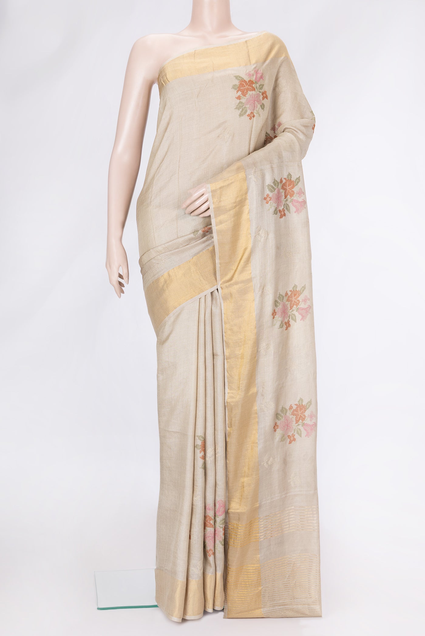 Beige Dual Tone Tussar Silk Saree with Embroidery on the body and Zari Border.  displayed on a mannequin