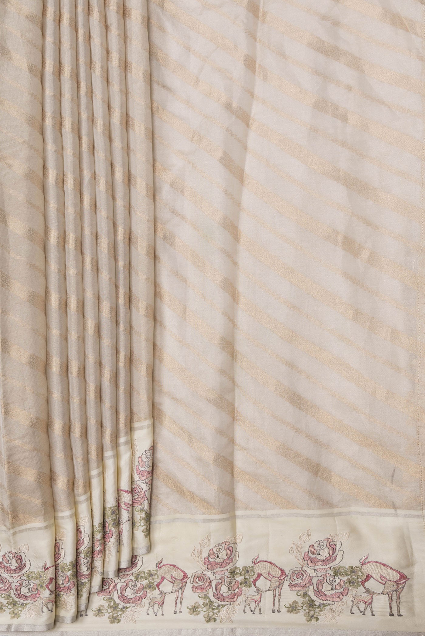 Pleats and pallu of Beige Dual Tone Organza Silk Saree with Zari Brocade on the body and Embroidery Border. 
