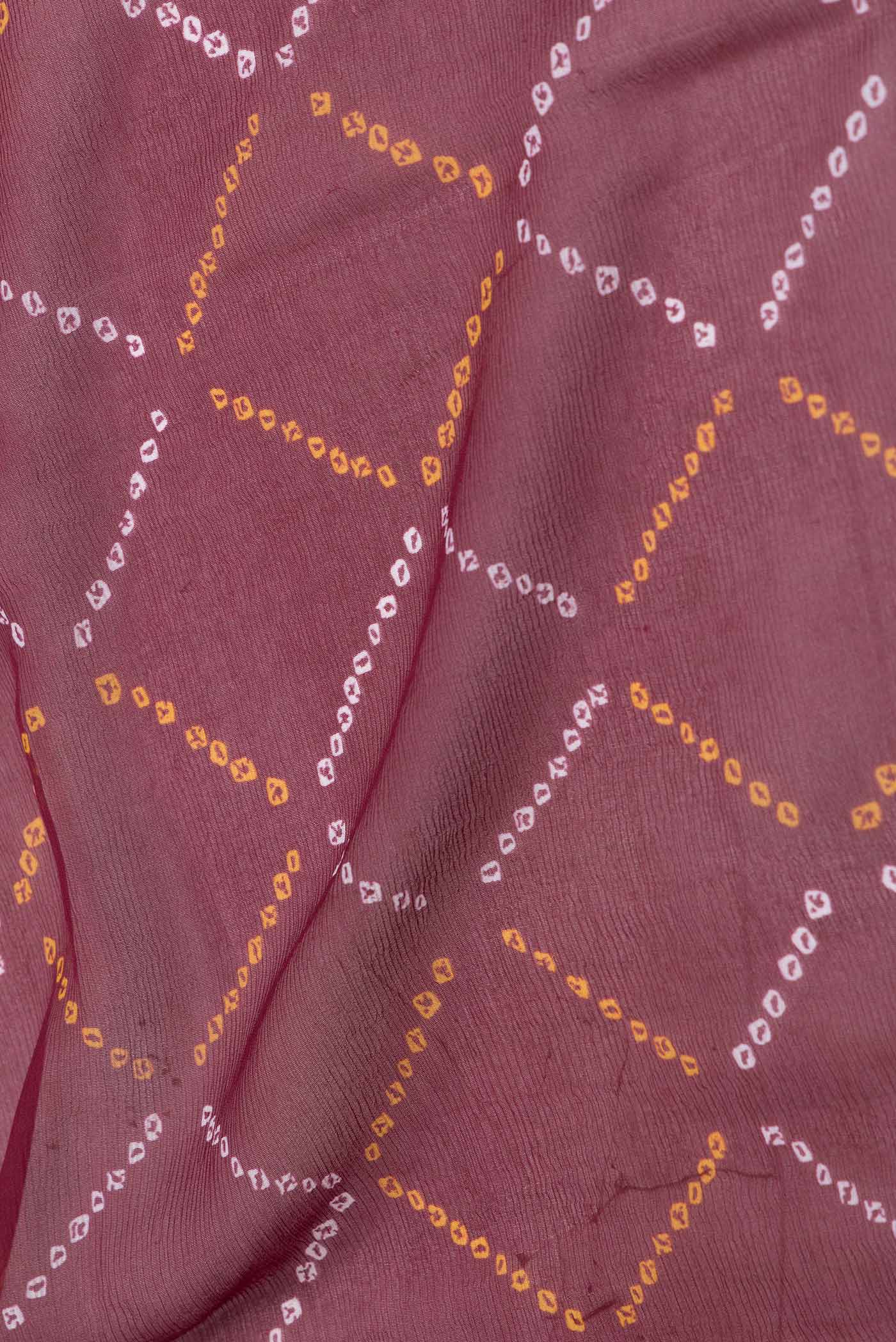 Close up of Maroon Dual Tone Mysore Chiffon Saree with Printed design on the body and Zari Border displaying folds