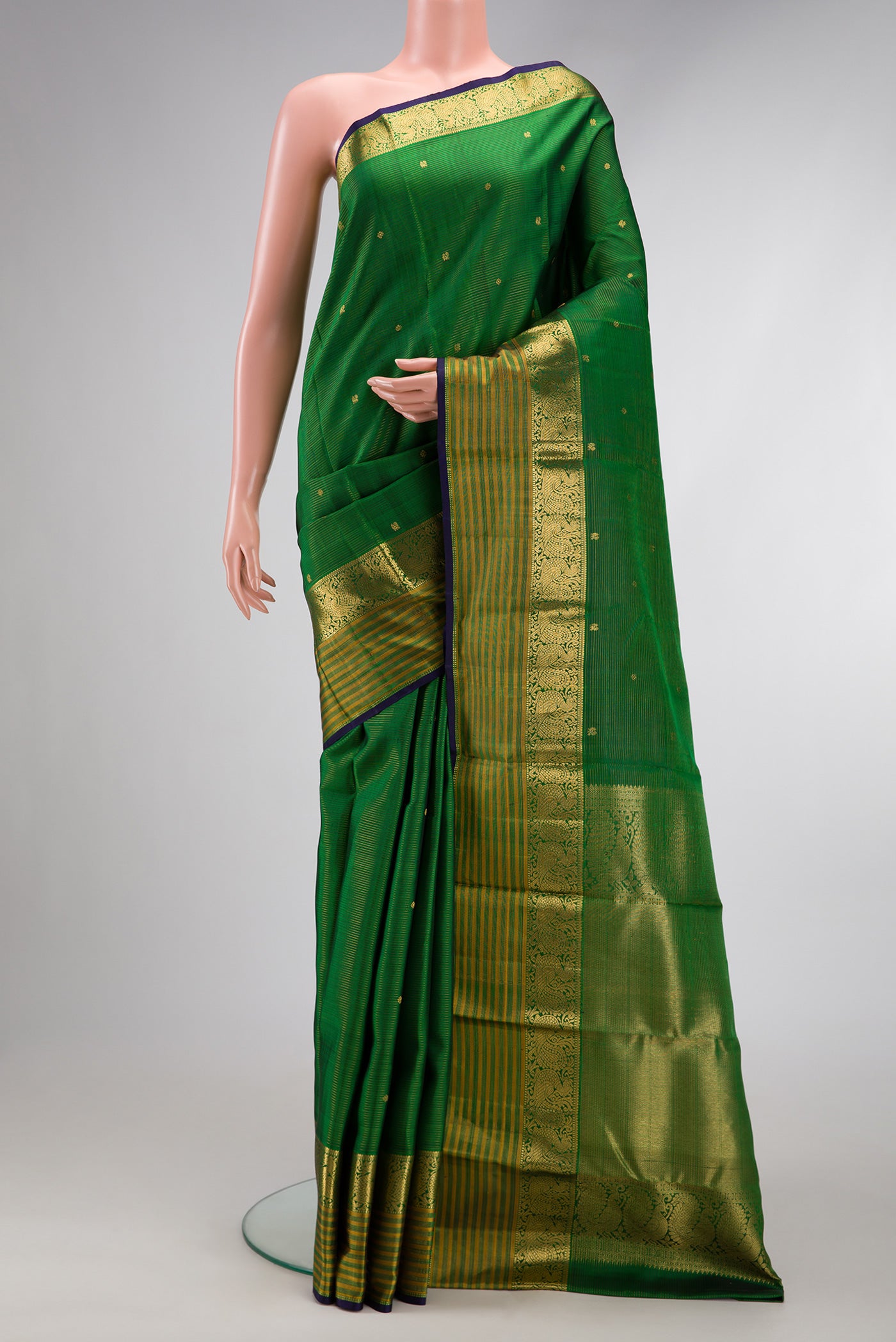 Green Dual Tone Kanjivaram Silk Saree with Stripes on the body and Zari Border.  displayed on a mannequin