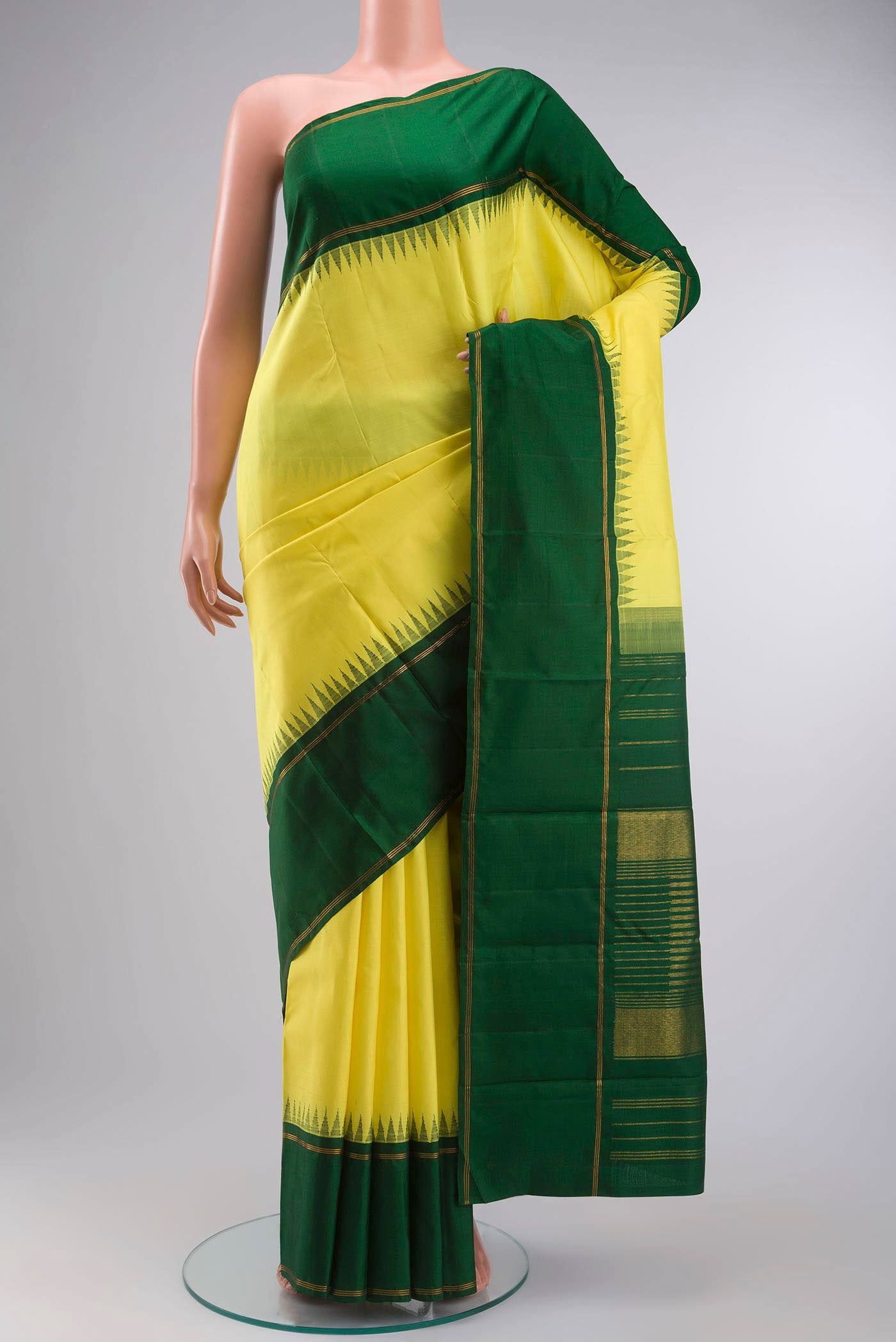 Yellow Kanchipuram Silk Saree with Plain Body and Zari Border displayed on a mannequin