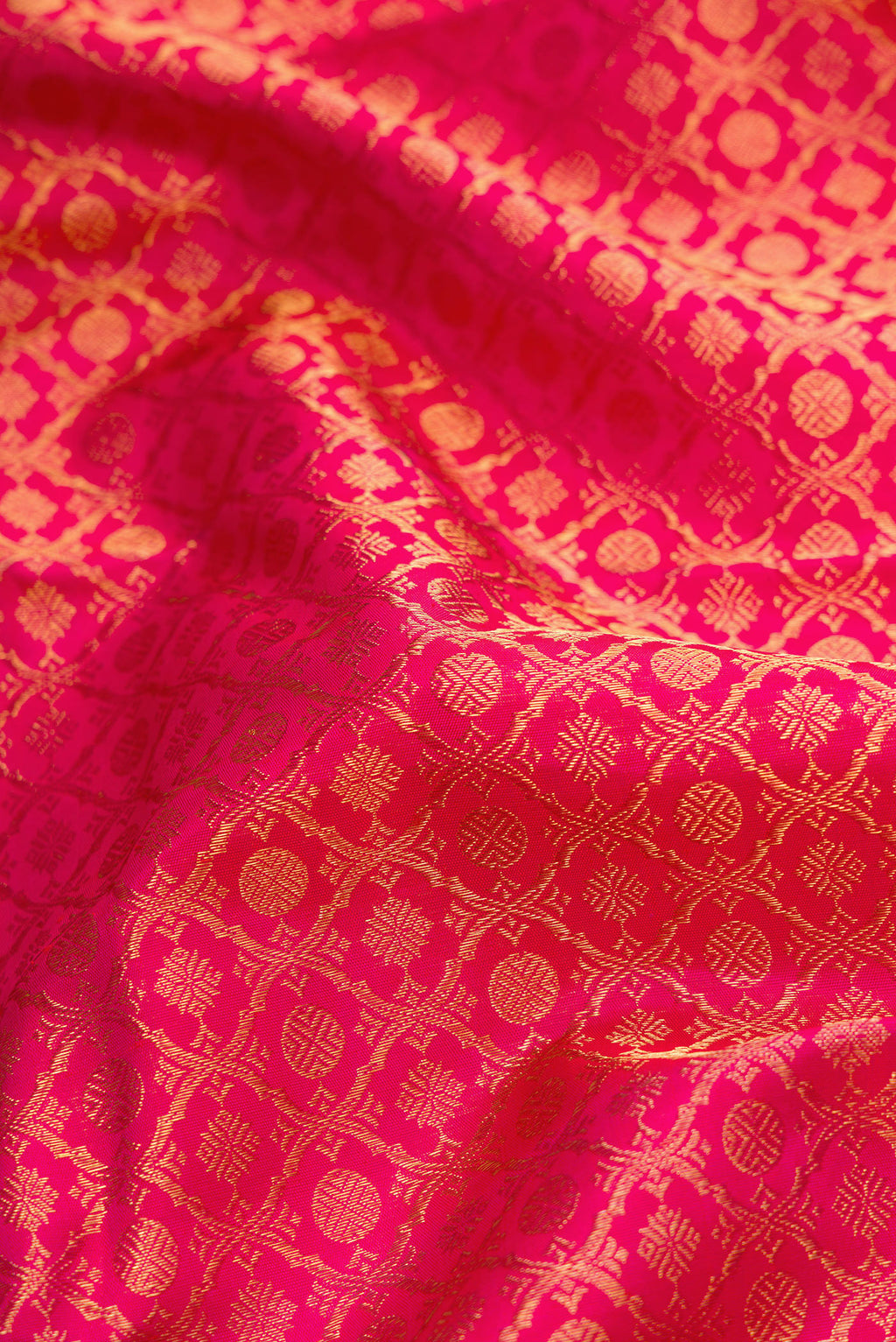 Close up of Pure Silk Pure Zari Pink Dual Tone Kanjivaram Saree with Zari Brocade on the body and Zari Border.  displaying folds