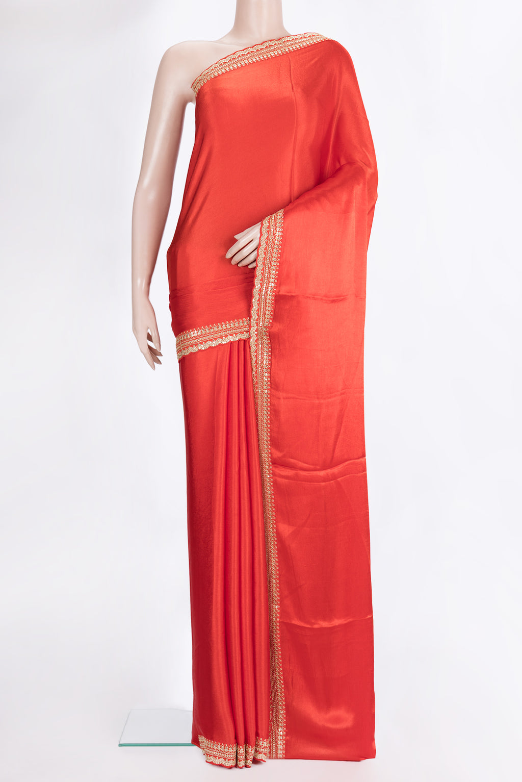 Brick Orange Crepe Saree with Plain Body and Sequin Border.  displayed on a mannequin