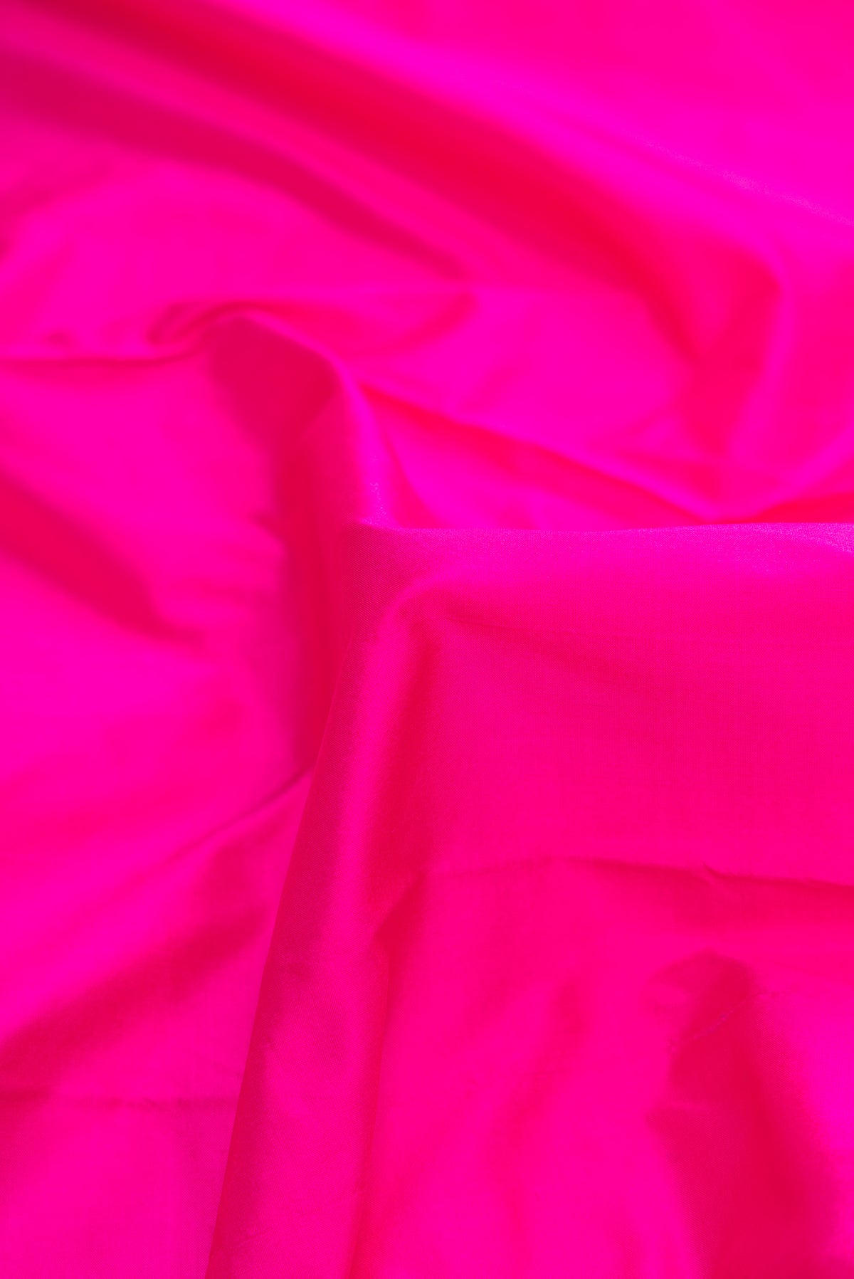 Close up of Pink Dual Tone Kanchipuram Silk Saree with Plain Body and Temple Border.  displaying folds
