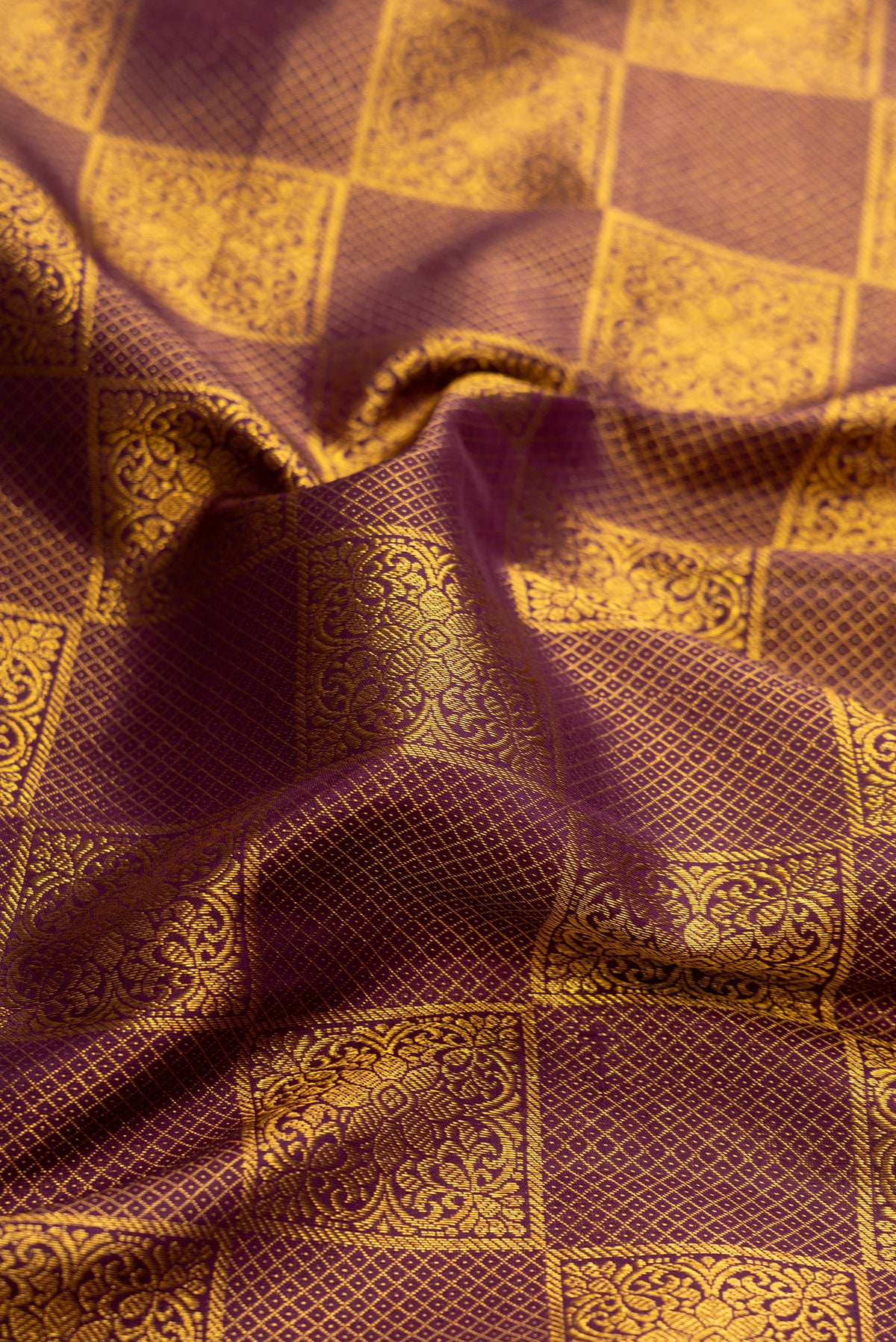 Close up of Brown Dual Tone Kanjivaram Silk Saree with Zari Brocade on the body and Zari Border.  displaying folds