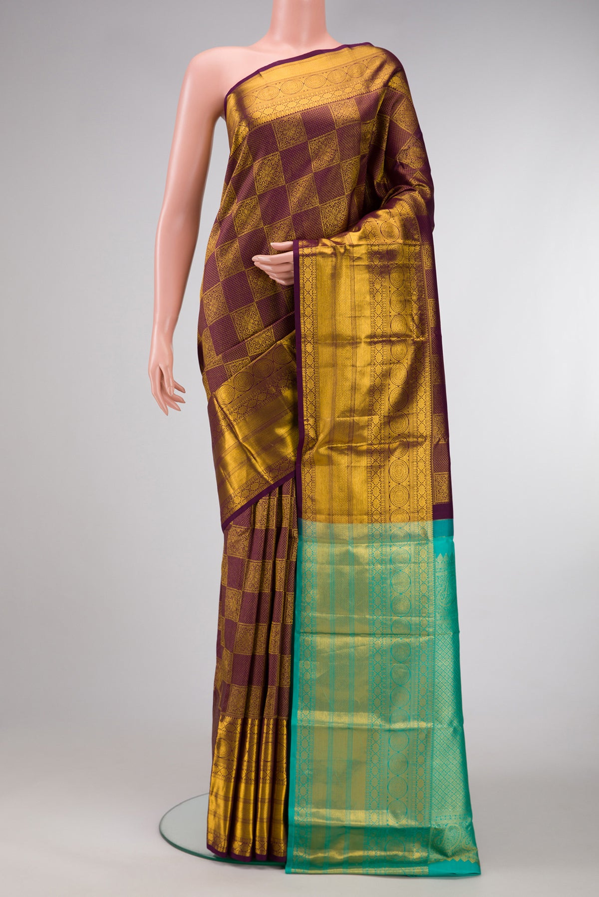 Brown Dual Tone Kanjivaram Silk Saree with Zari Brocade on the body and Zari Border.  displayed on a mannequin