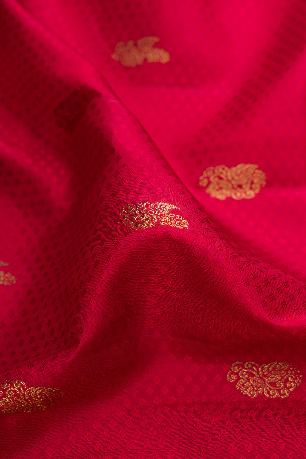 Close up of Pure Silk Pure Zari Red Dual Tone Kanjivaram Saree with Jacquard design on the body and Zari Border.  displaying folds