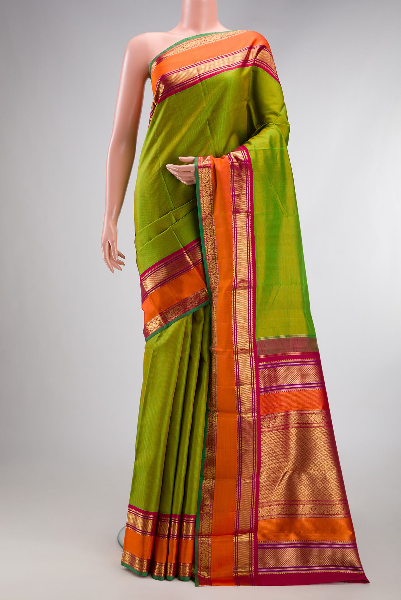 Pure Silk Pure Zari Parrot Green Kanjivaram Saree with Stripes on the body and Zari Border.  displayed on a mannequin