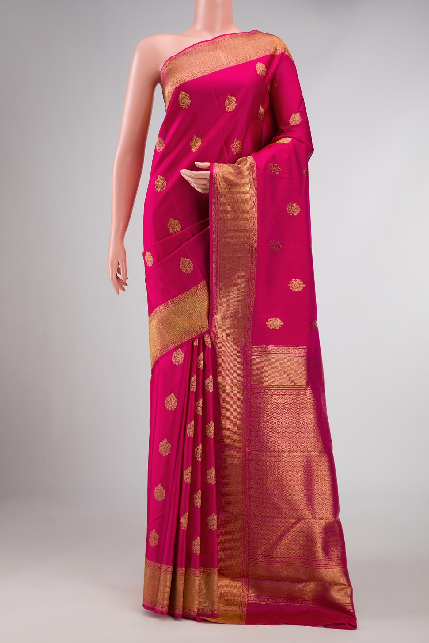 Pure Silk Pure Zari Dark Pink Dual Tone Kanchipuram Saree with Zari Butta on the body and Zari Border displayed on a mannequin