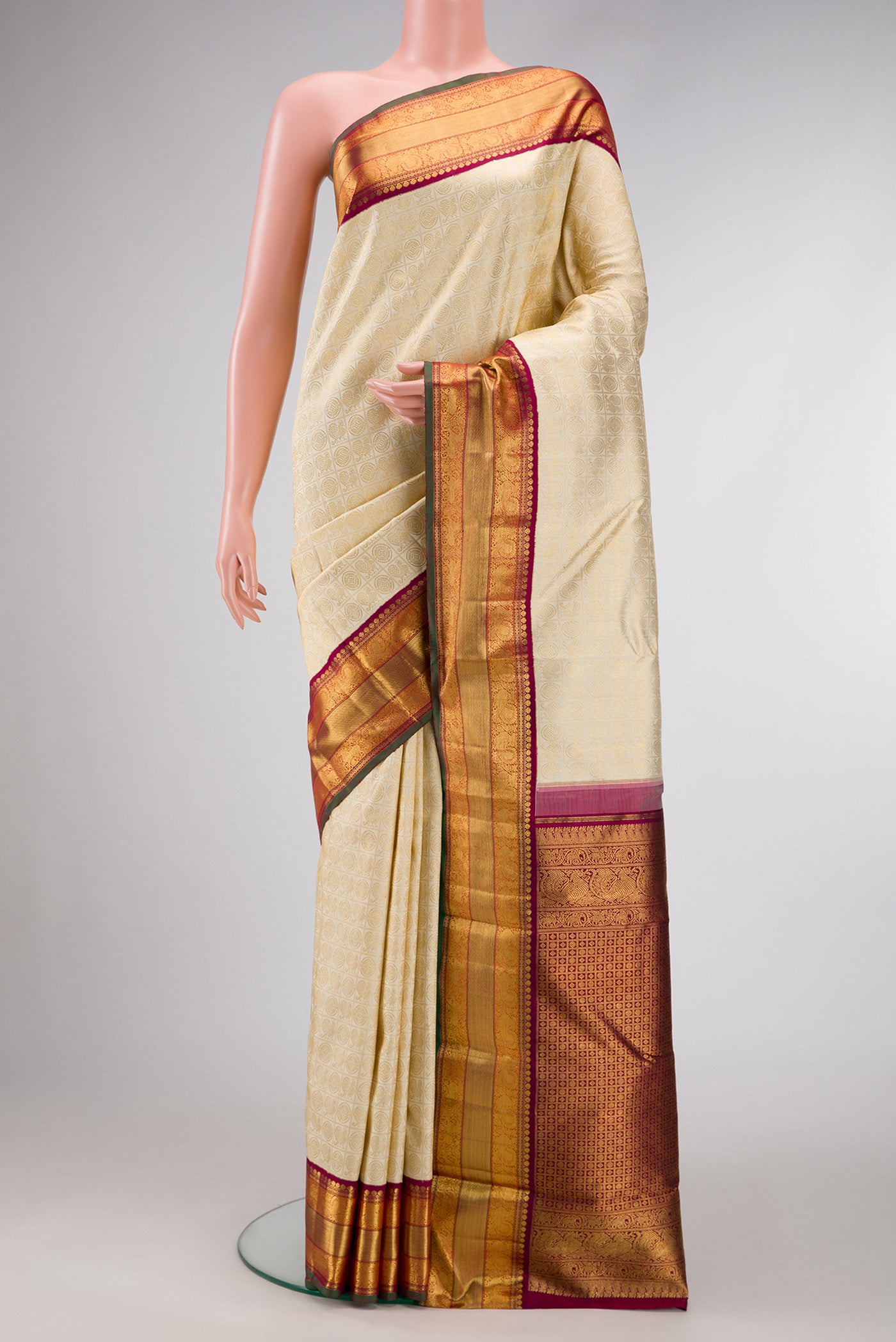 Pure Silk Pure Zari Off White Dual Tone Kanjivaram Saree with Zari Brocade on the body and Zari Border.  displayed on a mannequin