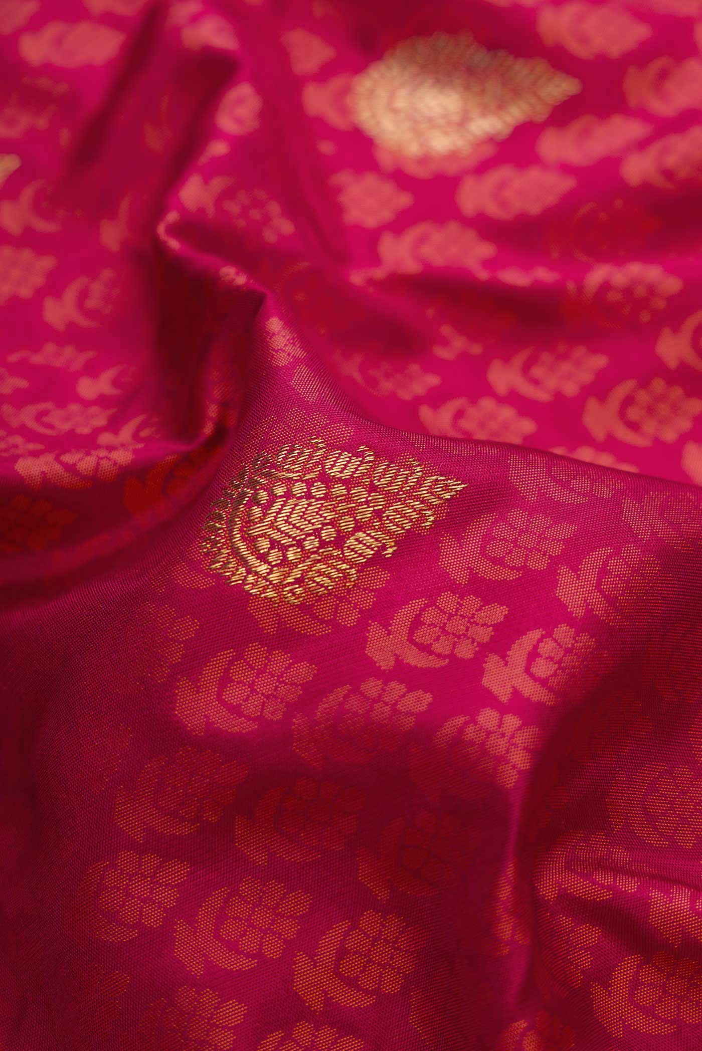 Close up of Pure Silk Pure Zari Maroon Dual Tone Kanchipuram Saree with Jacquard With Zari Butta on the body and Zari Border.  displaying folds
