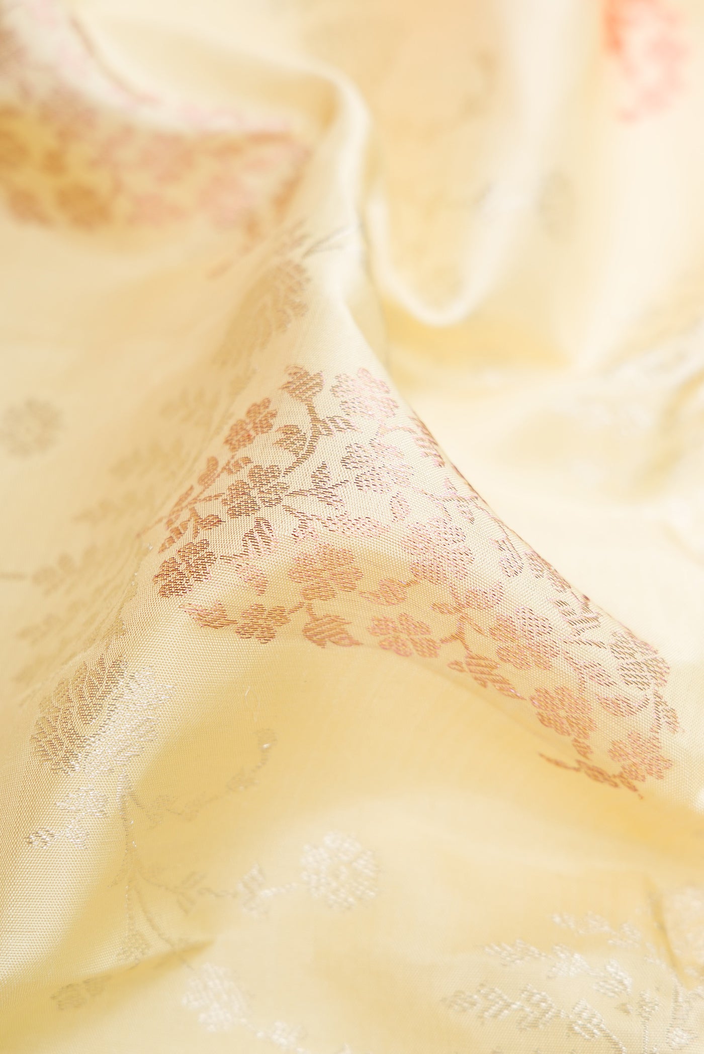 Close up of Pure Silk Pure Zari Pista Green Dual Tone Kanjivaram Saree with Zari Brocade on the body and Zari Border.  displaying folds