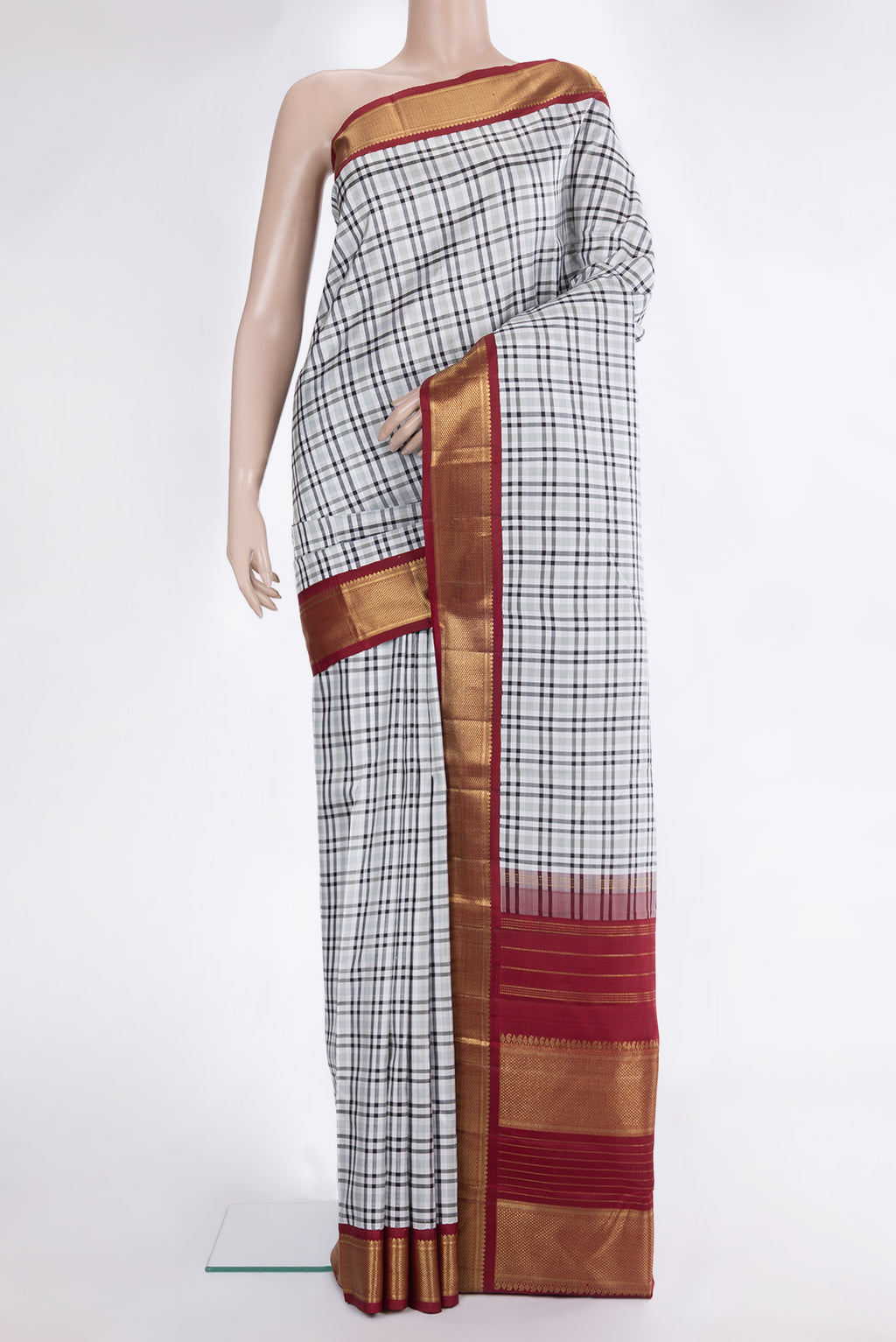 Pure Silk Pure Zari Off White Kanchipuram Saree with Checked design on the body and Zari Border.  displayed on a mannequin