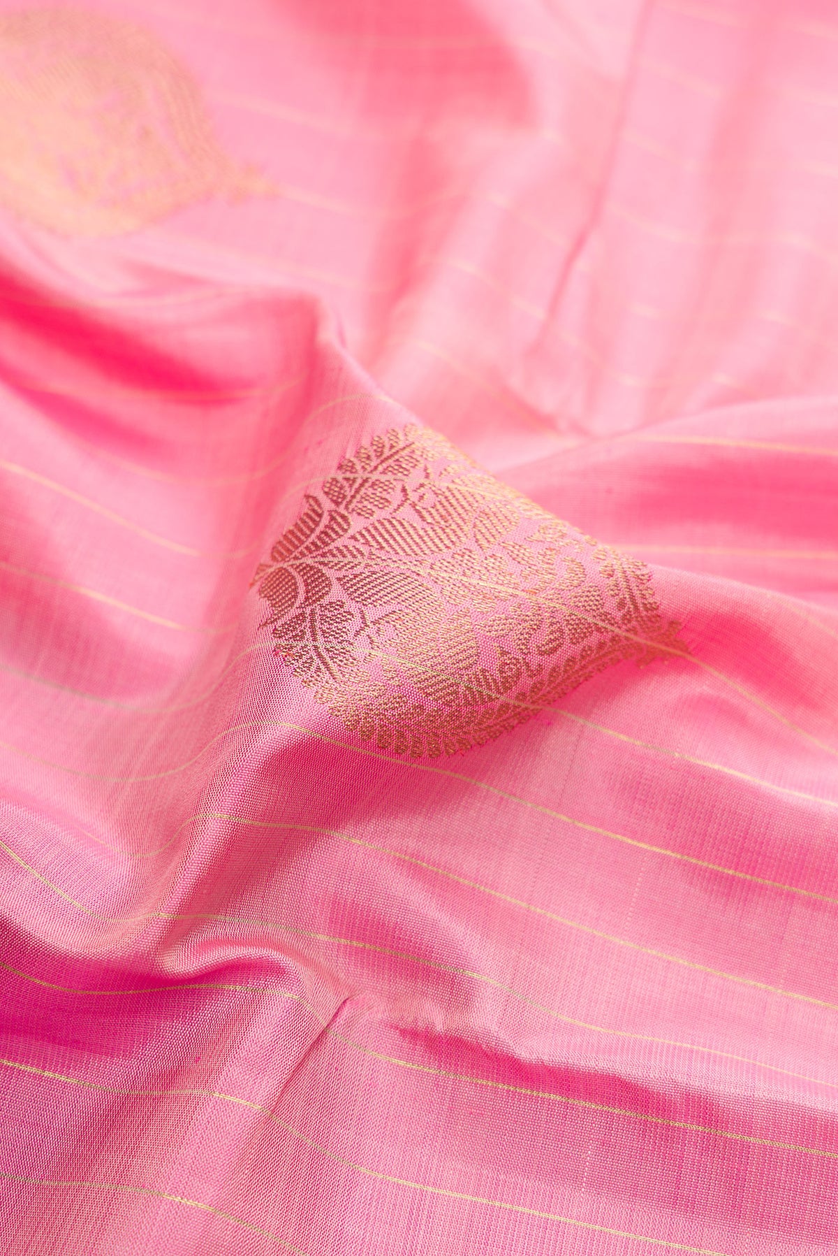 Close up of Pure Silk Pure Zari Rose pink Kanjivaram Saree with Zari Butta on the body and Fancy Border.  displaying folds