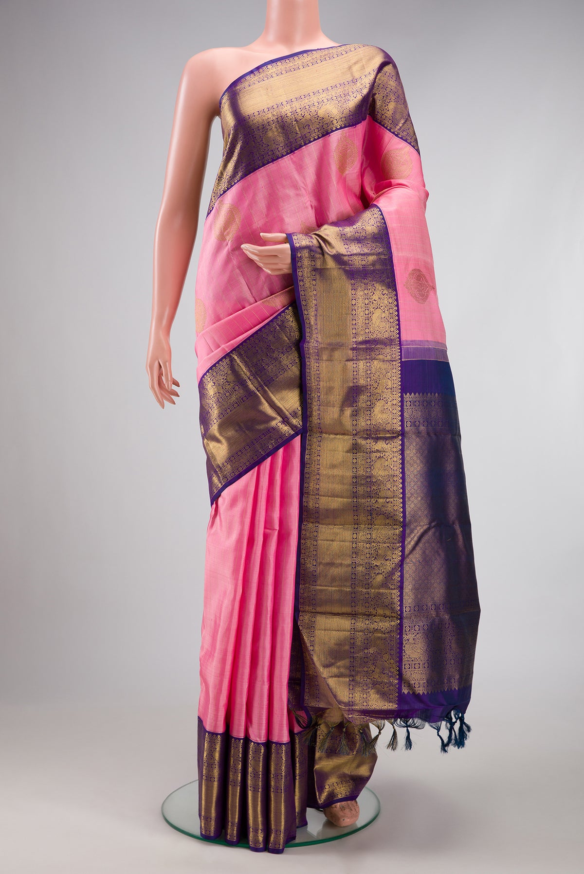 Pure Silk Pure Zari Rose pink Kanjivaram Saree with Zari Butta on the body and Fancy Border.  displayed on a mannequin
