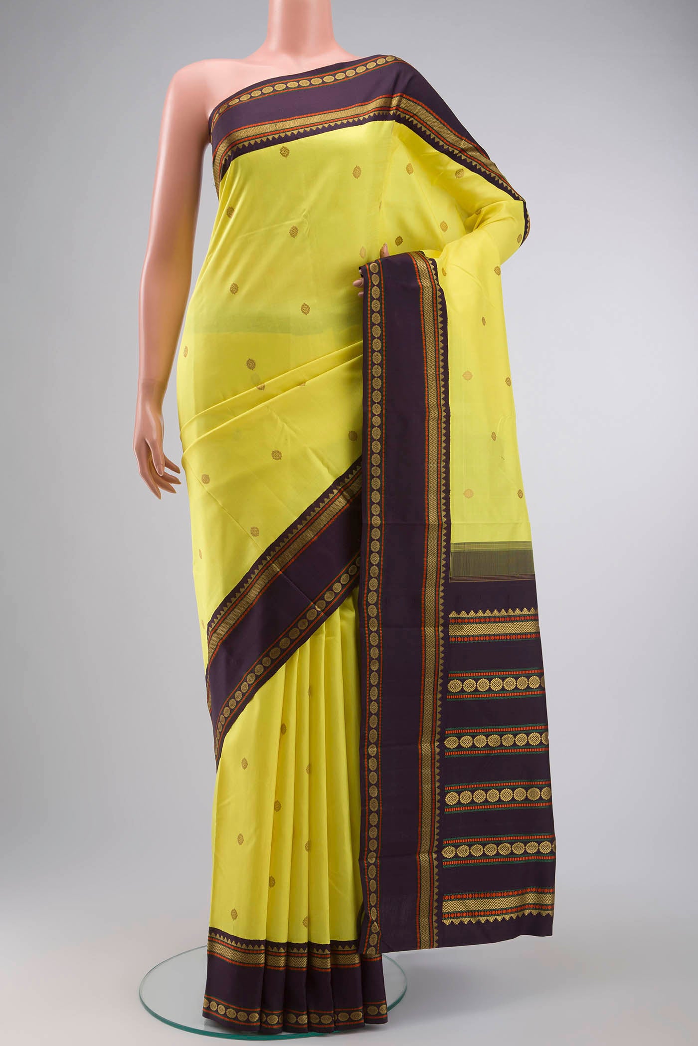 Yellow Kanchipuram Silk Saree with Thread Butta on the body and Thread Border displayed on a mannequin