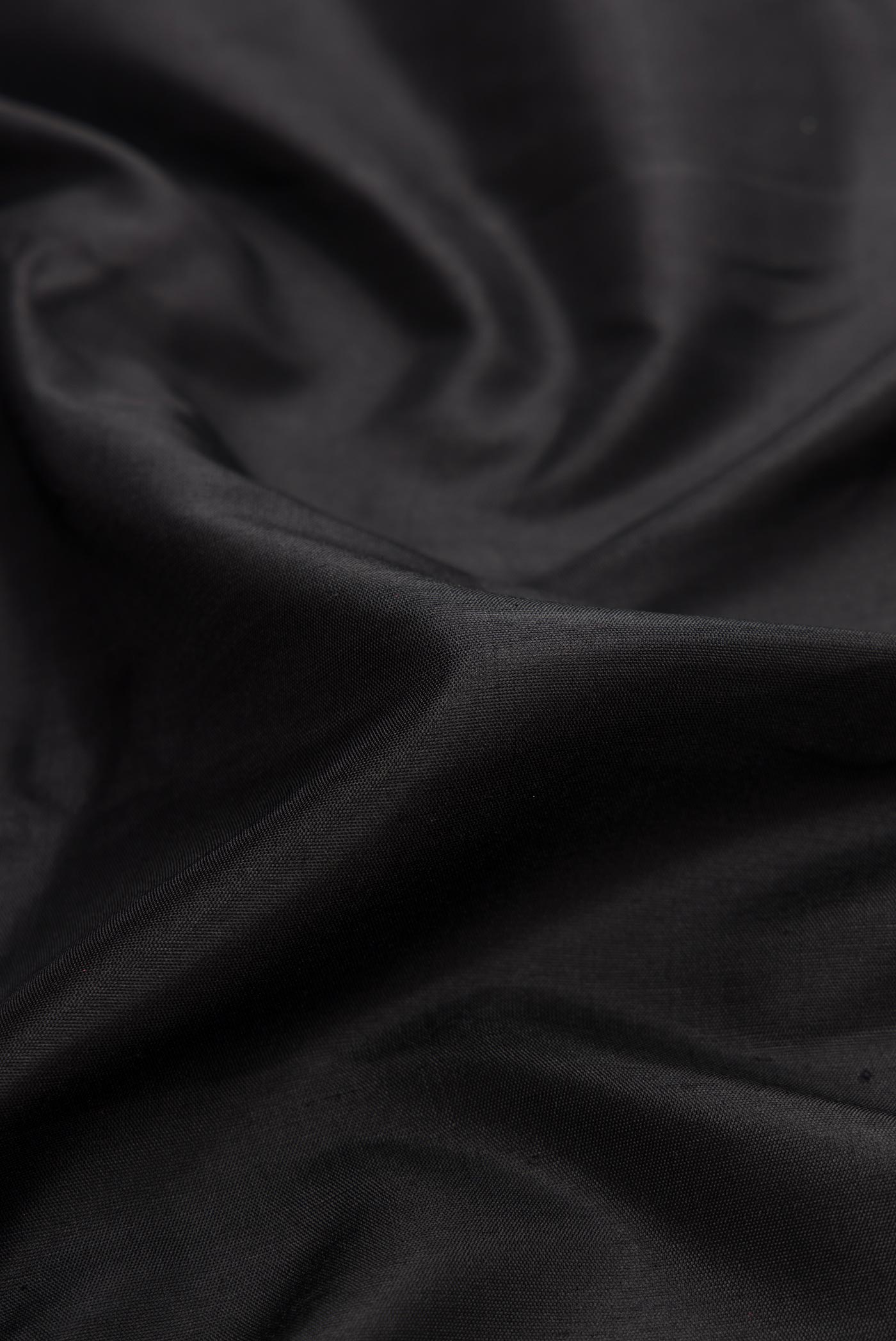 Close up of Black Dual Tone Gadwal Silk Saree with Plain Body and Zari Border displaying folds
