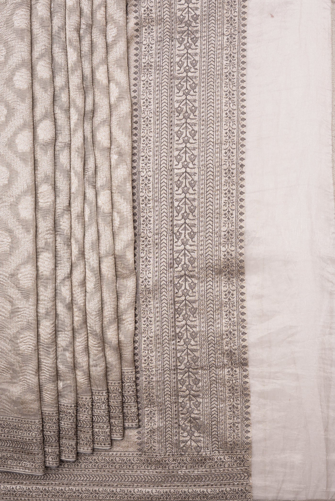 Pleats and pallu of Silver Dual Tone Organza Silk Saree with Zari Brocade on the body and Embroidery Border. 