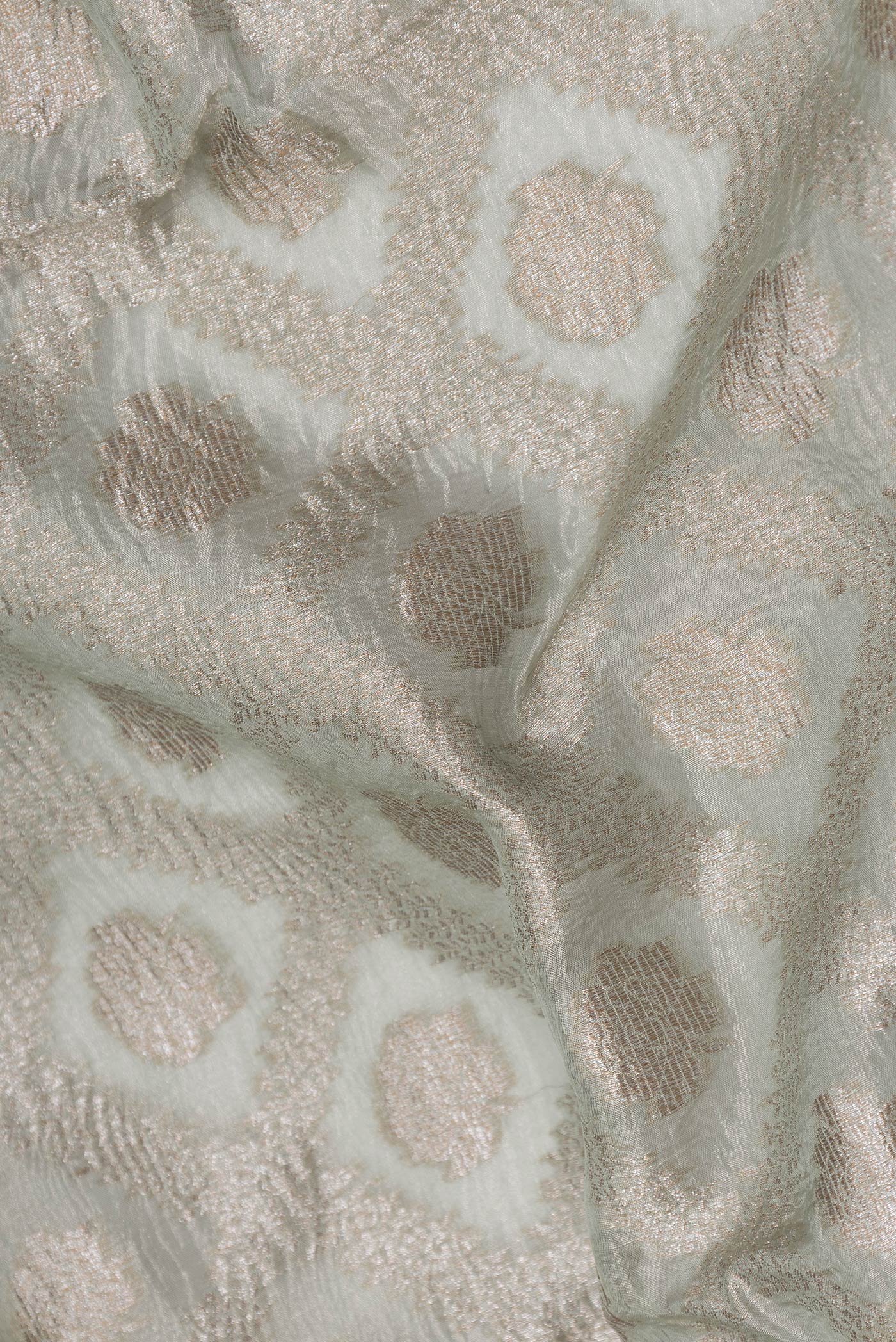 Close up of Pista Green Dual Tone Organza Silk Saree with Zari Brocade on the body and Embroidery Border.  displaying folds