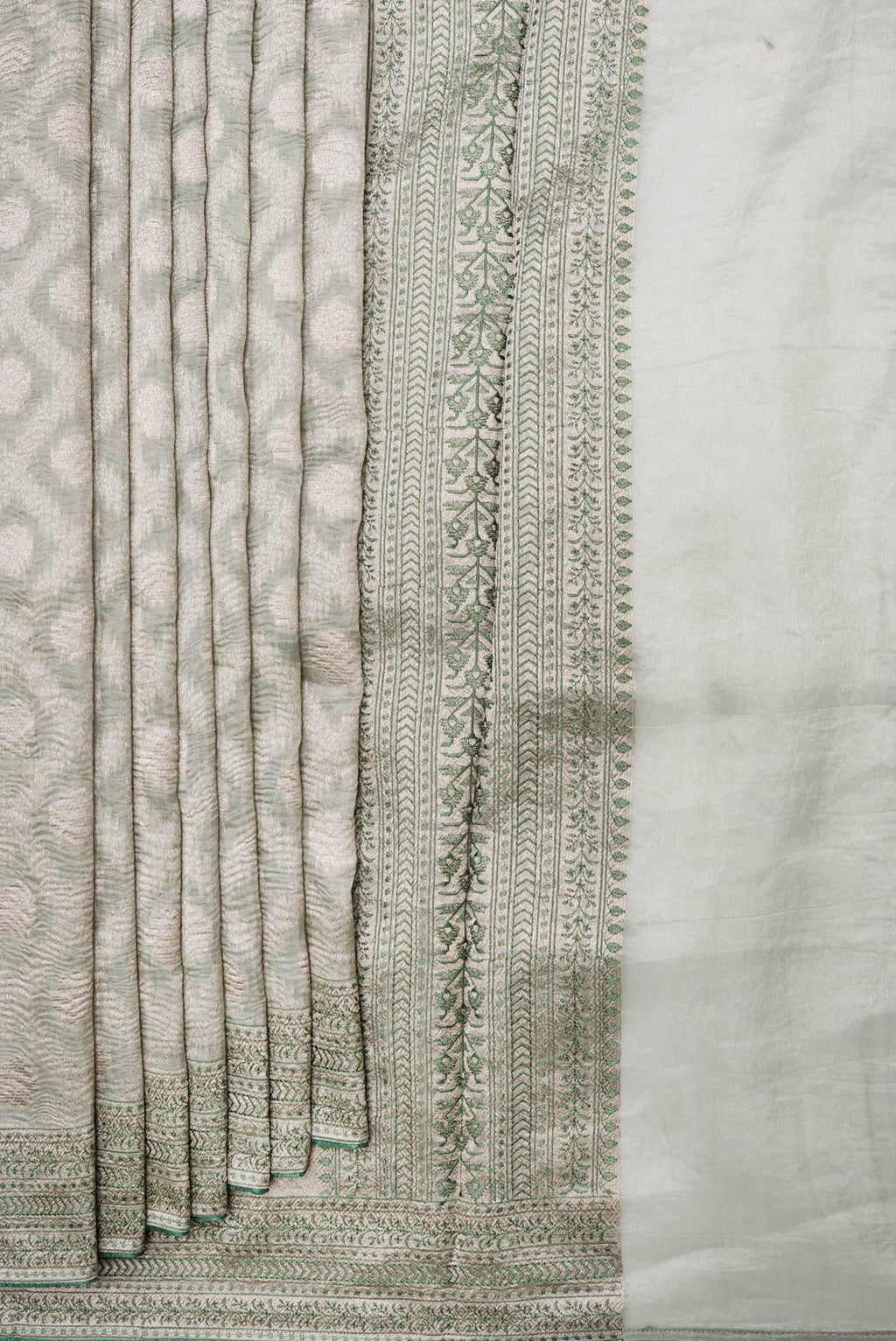 Pleats and pallu of Pista Green Dual Tone Organza Silk Saree with Zari Brocade on the body and Embroidery Border. 