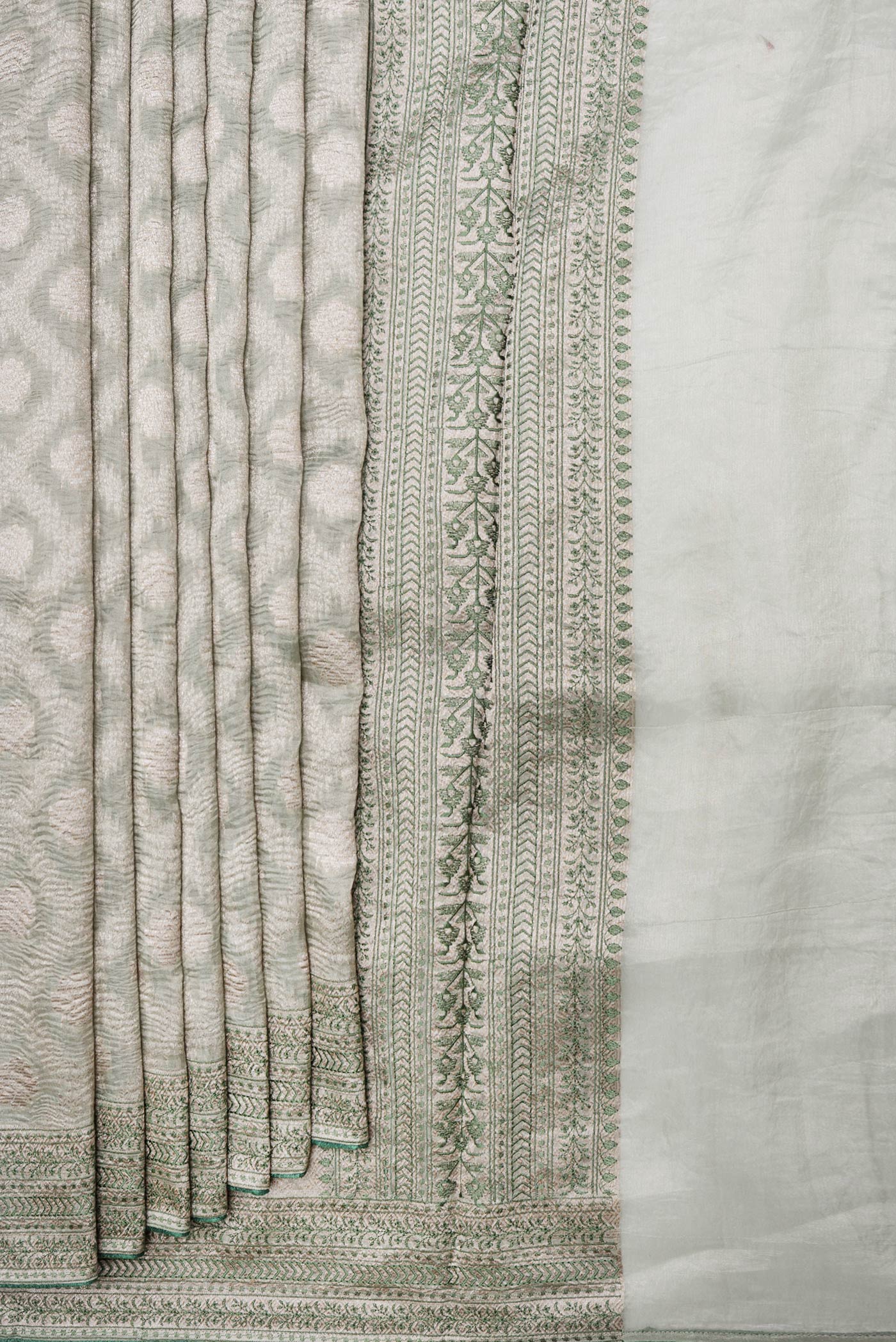 Pleats and pallu of Pista Green Dual Tone Organza Silk Saree with Zari Brocade on the body and Embroidery Border. 