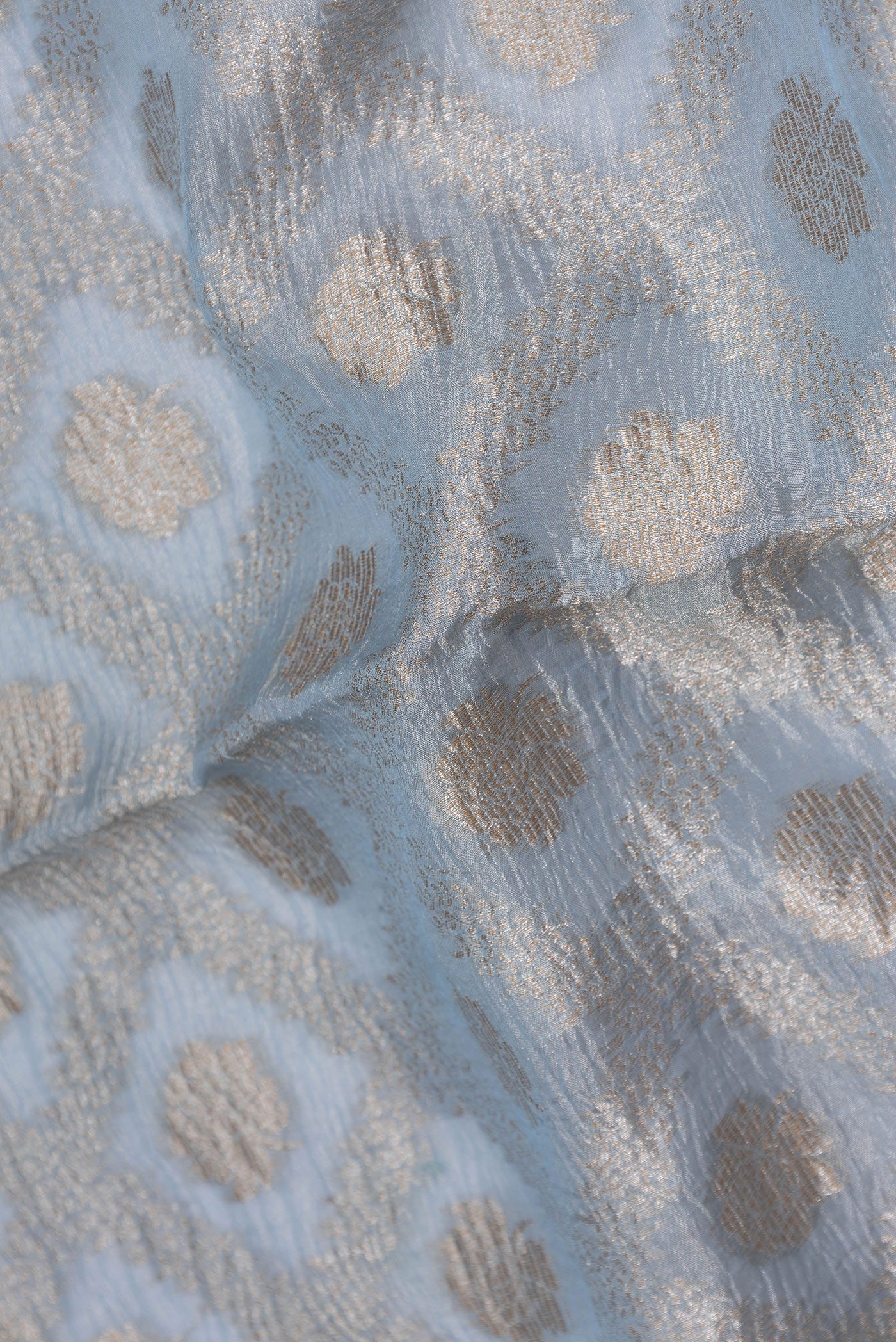 Close up of Light Blue Dual Tone Organza Silk Saree with Zari Brocade on the body and Embroidery Border.  displaying folds