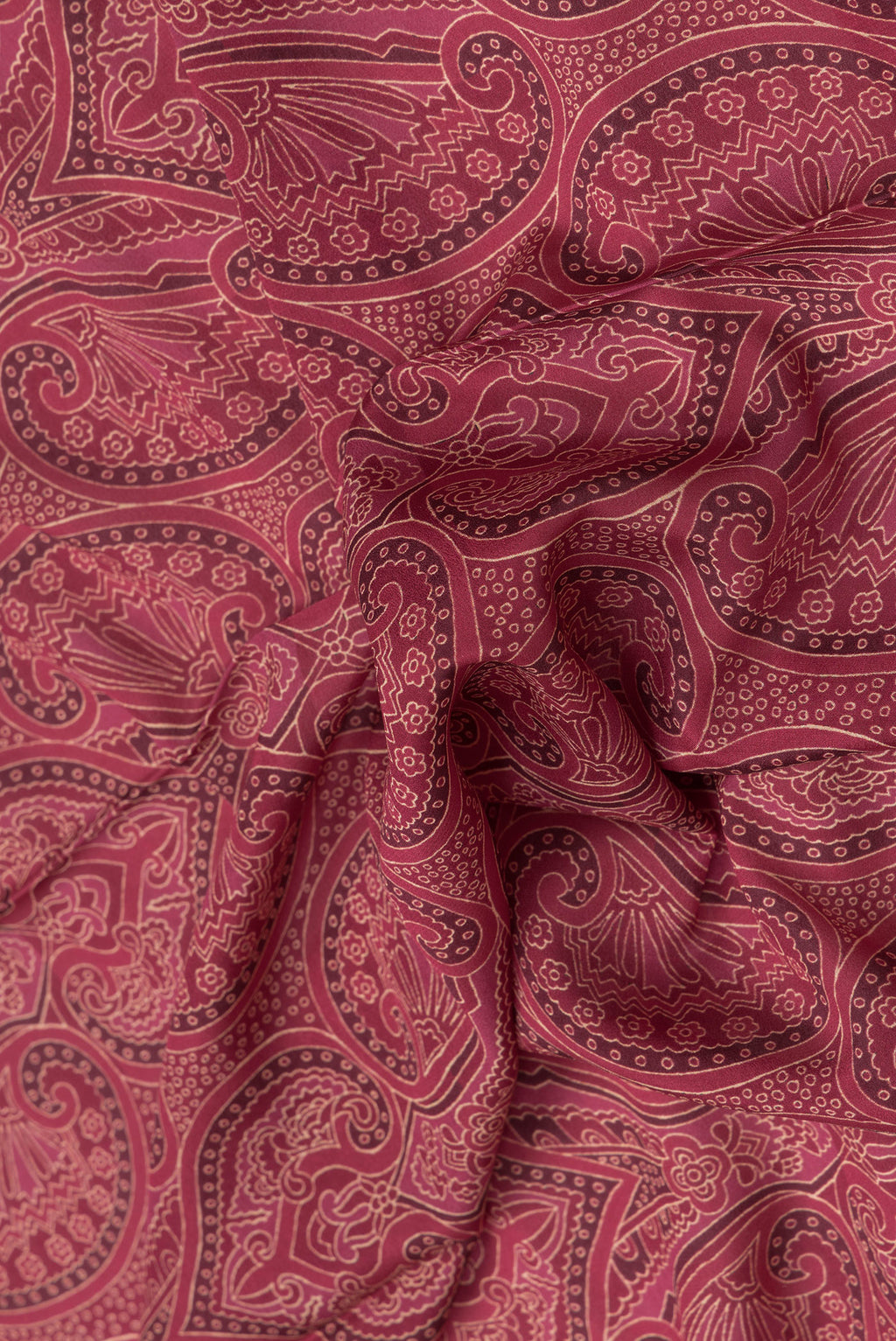 Close up of Maroon Dual Tone Mysore Crepe Saree with Printed design on the body and Zari Border.  displaying folds