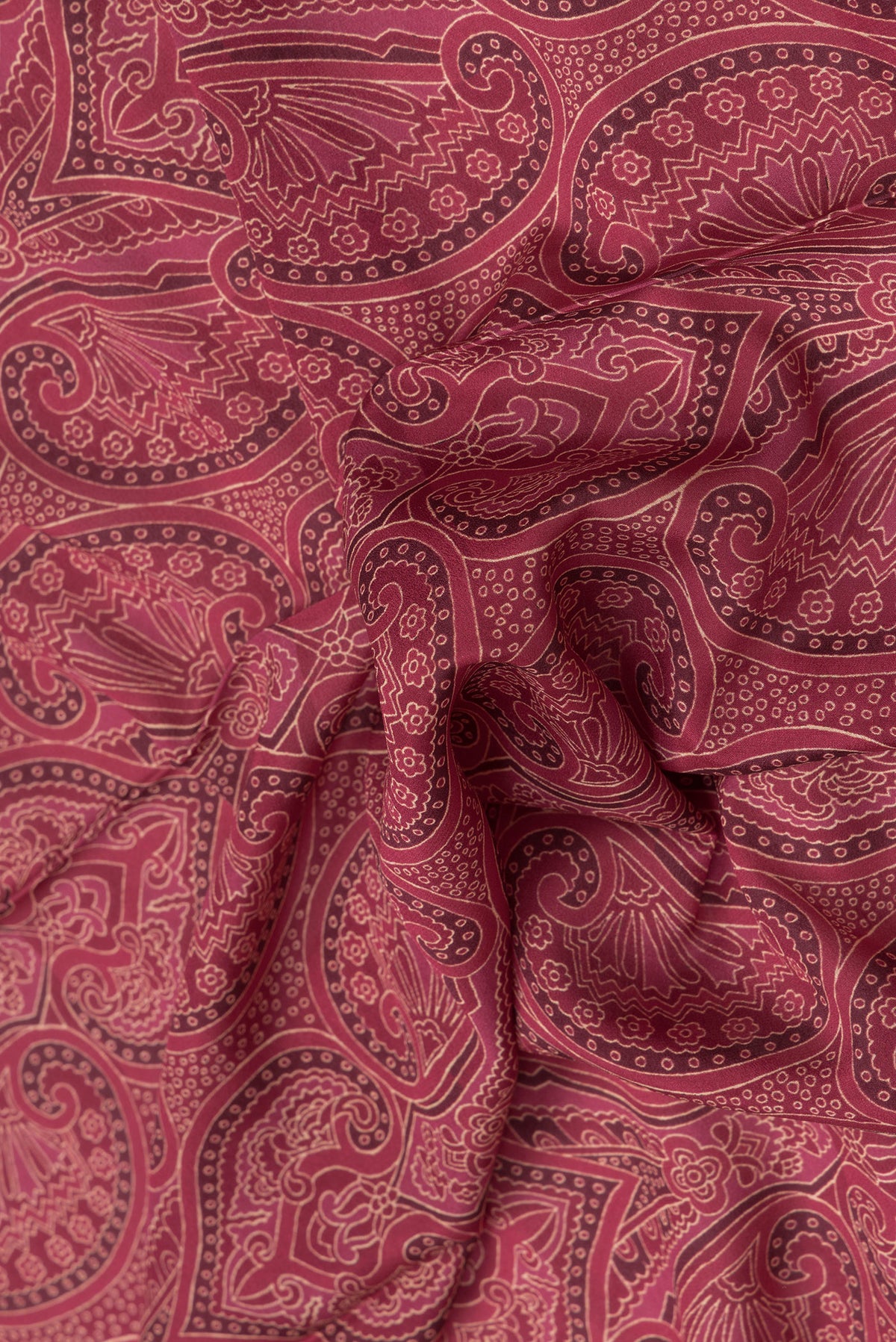 Close up of Maroon Dual Tone Mysore Crepe Saree with Printed design on the body and Zari Border.  displaying folds