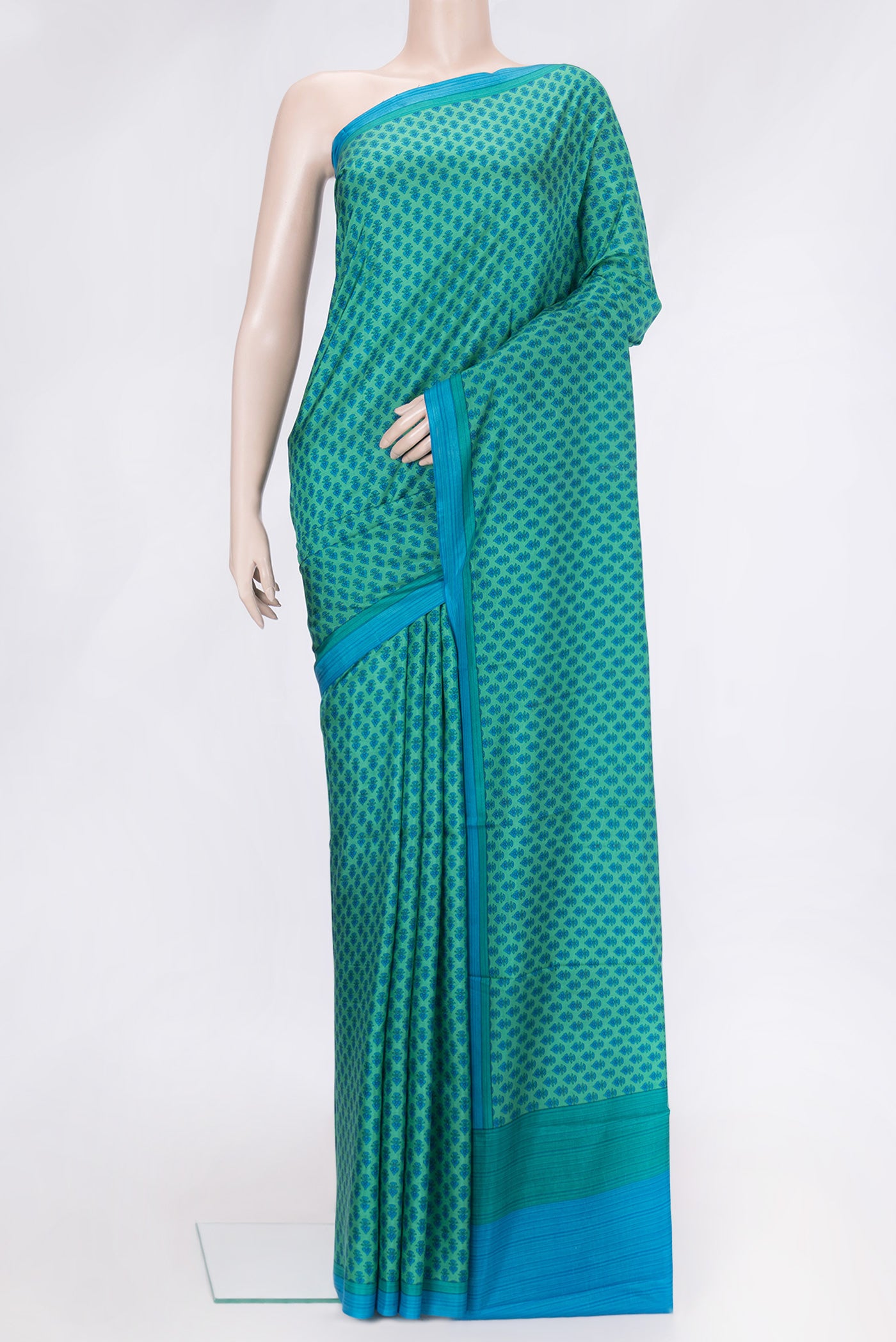 Green Dual Tone Printed Silk Saree with Printed design on the body and Plain Border.  displayed on a mannequin