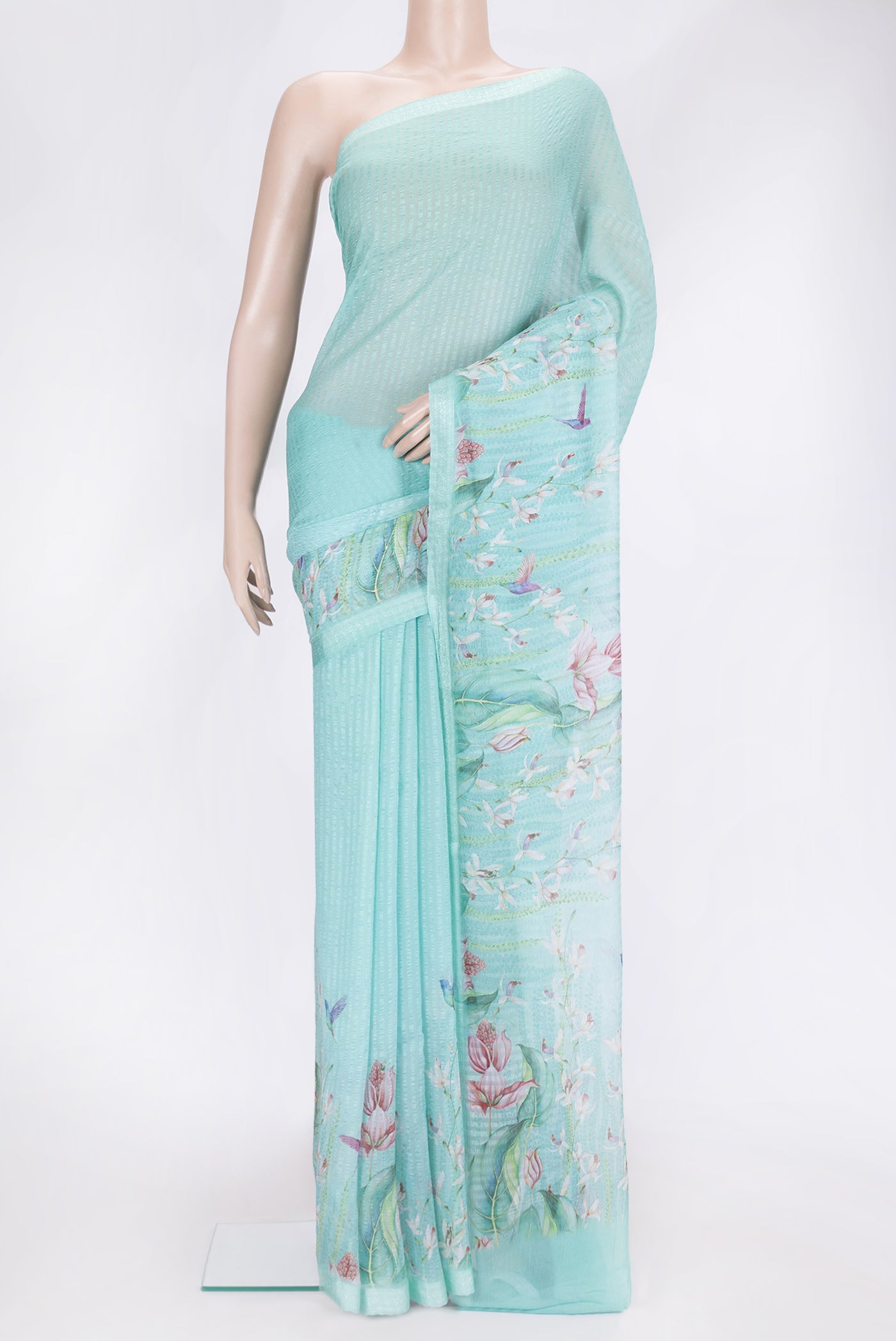 Sky Blue Dual Tone Mysore Chiffon Saree with Printed design on the body and Thread Border.  displayed on a mannequin
