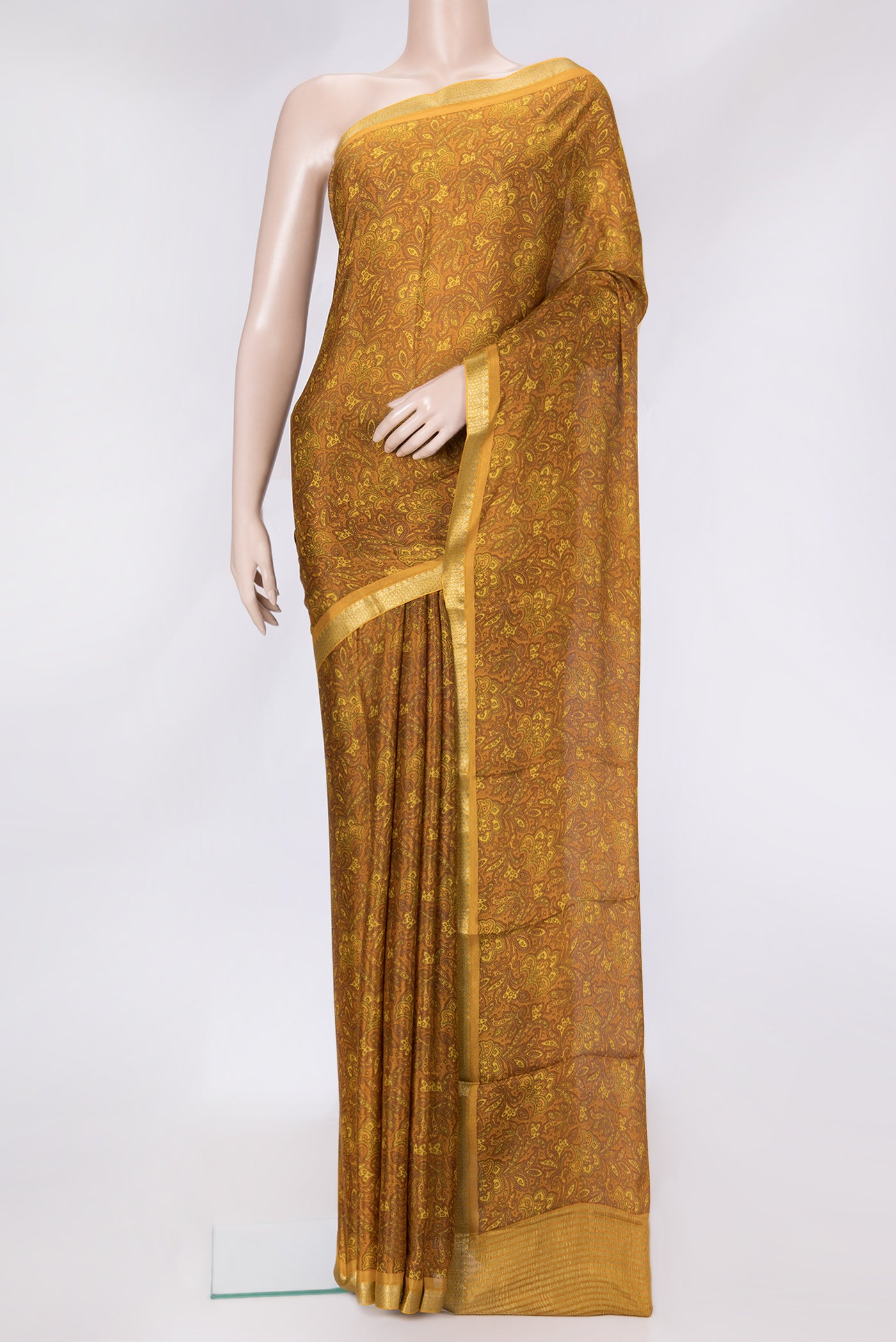 Mustard Dual Tone Mysore Crepe Saree with Printed design on the body and Zari Border.  displayed on a mannequin