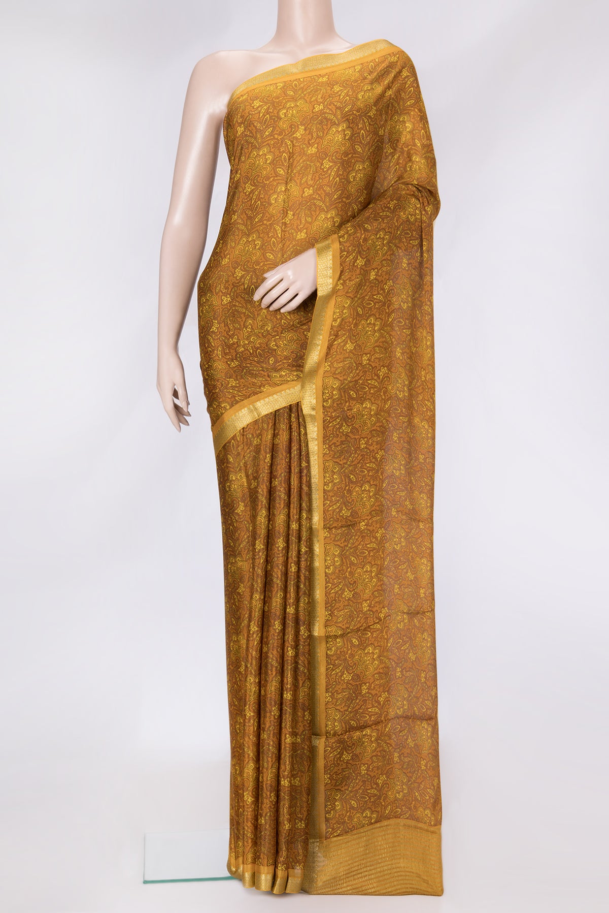 Mustard Dual Tone Mysore Crepe Saree with Printed design on the body and Zari Border.  displayed on a mannequin