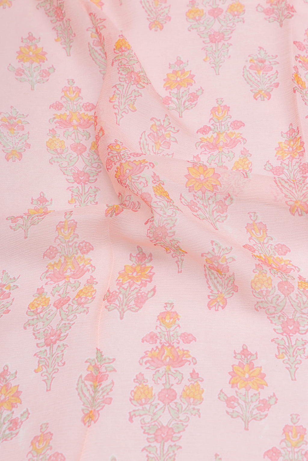 Close up of Rose Gold Mysore Chiffon Saree with Printed design on the body and Zari Border.  displaying folds